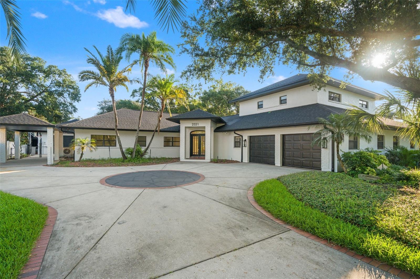 Discover an extraordinary lifestyle at 2521 Lake Ellen Drive, a masterfully reimagined luxury estate nestled along a quiet, tree-lined street in the prestigious heart of Carrollwood. Set on an expansive .46-acre homesite, this remarkable residence spans nearly 4,000 SF and offers 6 bedrooms, 5 1/2 bathrooms, a spacious 2-car attached garage, and the rare distinction of a 2-car detached garage—an exceptional blend of sophistication, comfort, and versatility.
From the moment you enter, soaring ceilings, gleaming marble flooring, and abundant natural light create a sense of grandeur and effortless elegance. The open-concept design is thoughtfully crafted for both refined entertaining and everyday living. At the center of the home, the gourmet chef’s kitchen showcases premium Miele appliances, exquisite waterfall countertops, custom cabinetry, and an oversized island that seamlessly connects to the main gathering spaces.
The lavish primary suite is a private sanctuary designed for relaxation and indulgence, featuring dual walk-in closets, a wet bar, a spa-inspired bath, and a secluded balcony overlooking the lush backyard oasis. A versatile bedroom with marble flooring offers the flexibility to serve as a sophisticated home office, private fitness studio, media lounge, or luxurious guest retreat. Generously sized secondary bedrooms and beautifully appointed bathrooms further enhance the home’s elevated appeal.
Beyond the interiors, a resort-caliber outdoor experience awaits. The spectacular backyard is designed to inspire unforgettable moments, highlighted by a stunning pool complete with a waterslide, grotto, spa, and a distinctive pool bath seamlessly integrated into the waterfall feature. Surrounded by lush tropical landscaping and a fully fenced yard, this private oasis offers the ultimate setting for relaxation and entertaining. Additional features include a porte-cochère and an air-conditioned rear garage.
Extensively updated for modern luxury living, the home features a new roof, updated plumbing, new HVAC systems, fresh interior and exterior paint, and numerous high-end enhancements throughout. Ideally positioned near premier shopping and dining destinations, Tampa International Airport, and major highways, this one-of-a-kind Carrollwood estate presents a rare opportunity to enjoy an exclusive lifestyle defined by elegance, privacy, and convenience.