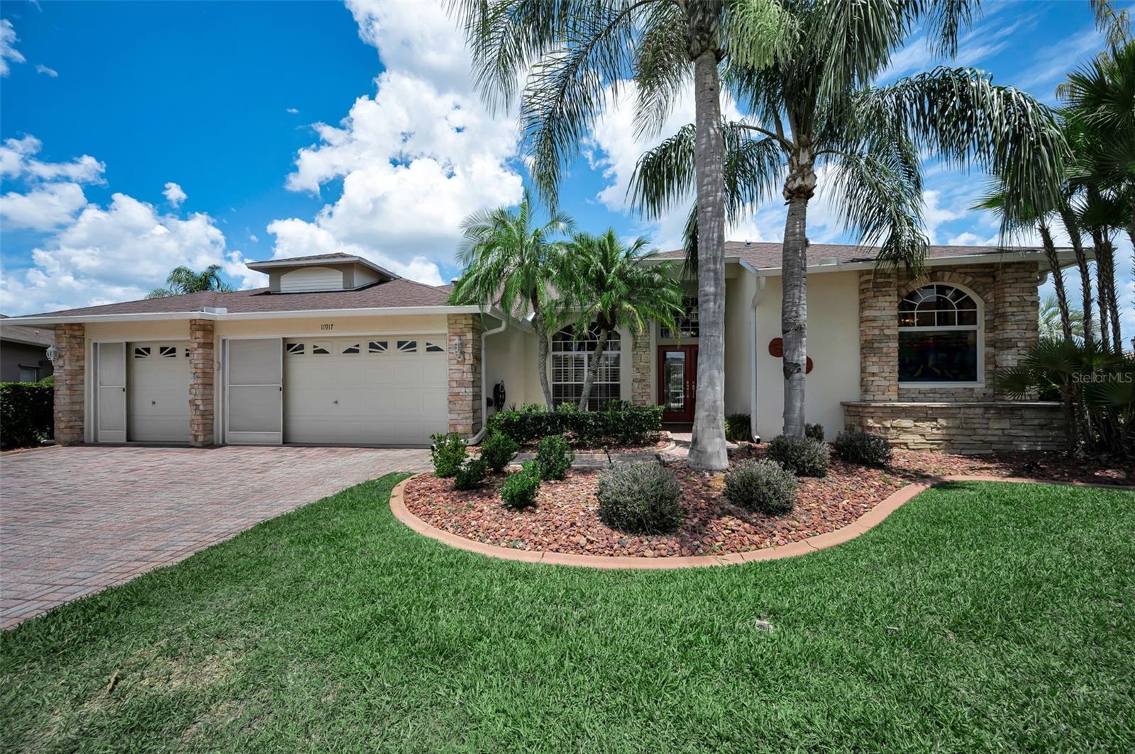 One or more photo(s) has been virtually staged. * WELCOME to 11917 Hadleigh Way!   * This  IMMACULATE , SPACIOUS  (2635 sq. ft.) , 4 br., 2 full bths.,  PLUS  2   half bths,  3 car garage (rare),  inground pool  , estate  home nestled on a quiet cul-de-sac awaits you!    *  Ideally located in the SOUGHT-AFTER  *   (55+)  HERITAGE SPRINGS  GOLF AND RESORT-STYLE COMMUNITY,, * 24hr. GUARD-GATED*   IN  DESIRABLE TRINITY!     * A WONDERFUL OPPORTUNITY !     * Beautiful curb appeal as it is nicely landscaped with matured trees, hedges,  plants , PAVERED driveway & walkway, and a beautiful stone accent design on parts of the exterior.  *  As you enter the front double doors  you will find a very appealing floor-plan and so versatile for everyday living and entertaining! *  Livingroom and dining room has ceramic tile, nice arched windows for added light and a slider out to the lanai with view of the pool. *  Split bedroom floorplan*  The primary bedroom is towards the front of the home .  * It is of ample size , laminate flooring , his/hers walk-in closets, and a slider out to lanai and pool. *  The primary masterbath is spacious and has double sinks, walk-in shower, linen closet, an big arched window for light and a relaxing separate garden tub.  *  The kitchen has a generous amount of cabinets and space for cooking,  a nice eating area , a beautiful large glass window with view of the pool /yard AND it is open to the family room which is so desirable!  *  Familyroom is a great size for entertaining with large sliders out to th pool.  *  Second and third bedroom are off the family room with the hall/guest bath in between.  The 4th bedroom is in the back for nice privacy and  has a built-in closet . Lastly, the sparkling pool and lanai area is so inviting!  In the lanai area, you will find the EXTRA  1/2 bath which is so  convenient .   Also there is a separate sink/small area to put drinks, cabinets , and storage. *  There is generous space to sit out  and enjoy the nicely landscaped lot with ( NO REAR NEIGHBORS) , the corner pond-view , drink your favorite beverage, take a dip in the inviting pool,  and RELAX IN THE FLORIDA SUNSHINE AND LIVING! *  YOUR OWN PRIVATE OASIS!  *  Laundry room is large and accomodates a washer/dryer, linen closet, EXTRA 1/2 BTH , cabinet, and a solar tube skylight for natural light.  The 3-car garage is rare  ( ideal for a golf-cart, 3rd vehicle, workshop , has extra cabinets for storage,  refrigerator for  extra beverages, pull-down stairs for attic access and a screen garage door enclosure (manual).    * Residents of this premier( 55+) HERITAGE SPRINGS COMMUNITY enjoy resort-style amenities, including the championship Robert Trent Jones 18-hole golf course, clubhouse , community pool/spa, fitness center , tennis courts, shuffleboard, picnic area, restaurant, social events and activites, cards, crafts, library , billiards/pooltables, and all are within 24hr guard-gated and beautifully maintained community !   RELAX AND ENJOY IT ALL!  *  Conveniently located to shopping , churches, medical/professional offices, hospital, dining, beaches, gulf, and an easy drive to  the Suncoast Pkwy, Tampa International Airport and Clearwater/St. Pete Airport.   FLORIDA LIVING AT ITS BEST!    MAKE YOUR DREAM HOME A REALITY!   *  Roof (2020) *  A/C (2016)  * HWH - ( 2019).  *     Call today for your private tour!  Thank you!