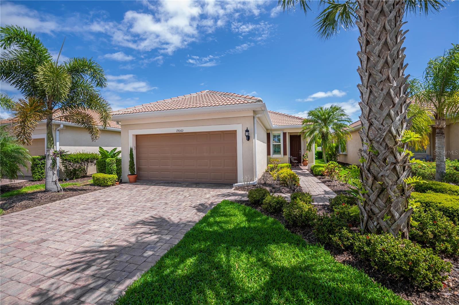 Welcome to this beautifully maintained 3-bedroom, 2-bath home in the highly sought-after IslandWalk community, where style, comfort, and easy Florida living come together effortlessly. From the moment you arrive, the paver driveway and walkway create inviting curb appeal and set the tone for what’s inside. Designed with both convenience and peace of mind, the home features easy-to-use hurricane shutters—simply pull and lock for quick protection. Step inside to a light, bright interior with thoughtful upgrades throughout. The remodeled kitchen is a standout, offering additional cabinetry, GRANITE COUNTERTOPS, enhanced lighting, pull-out shelving in all lower cabinets and large pantry cabinet, and soft-close doors—perfect for both everyday living and entertaining. The home features durable vinyl plank flooring in the bedrooms and closets, while the main living areas are tile and enhanced with modern LED lighting in the dining and living rooms. To add to the charm and elegance are PLANTATION SHUTTERS in most rooms. Sliding glass doors are dressed with Hunter Douglas shades, adding both privacy and a refined touch. Additional upgrades include: insulated garage door, overhead garage storage, new wood valance and side molding, whole house surge protector, and recently replaced hot water heater 2019 (meticulously maintained with annual servicing). Both bathrooms have been tastefully updated, including a sleek tempered glass shower door designed for easy maintenance. Outside, regularly maintained gutters reflect the care and attention given to this home. This move-in ready property offers a perfect blend of modern updates, functionality, and low-maintenance living—all within one of Venice’s premier gated communities. Enjoy IslandWalk’s resort-style amenities, including multiple pools and clubhouses, state-of-the-art fitness center, tennis and pickleball courts, miles of walking trails, picturesque lakes and bridges, and a full calendar of social activities, and a full time activities director—just minutes from Gulf beaches, Atlanta braves Spring training facility, shopping, dining, and downtown Wellen Park where you will find concerts in the park, weekly farmer's market, dining, coffee cafes, and shops. Schedule your private showing today and experience the IslandWalk lifestyle for yourself.