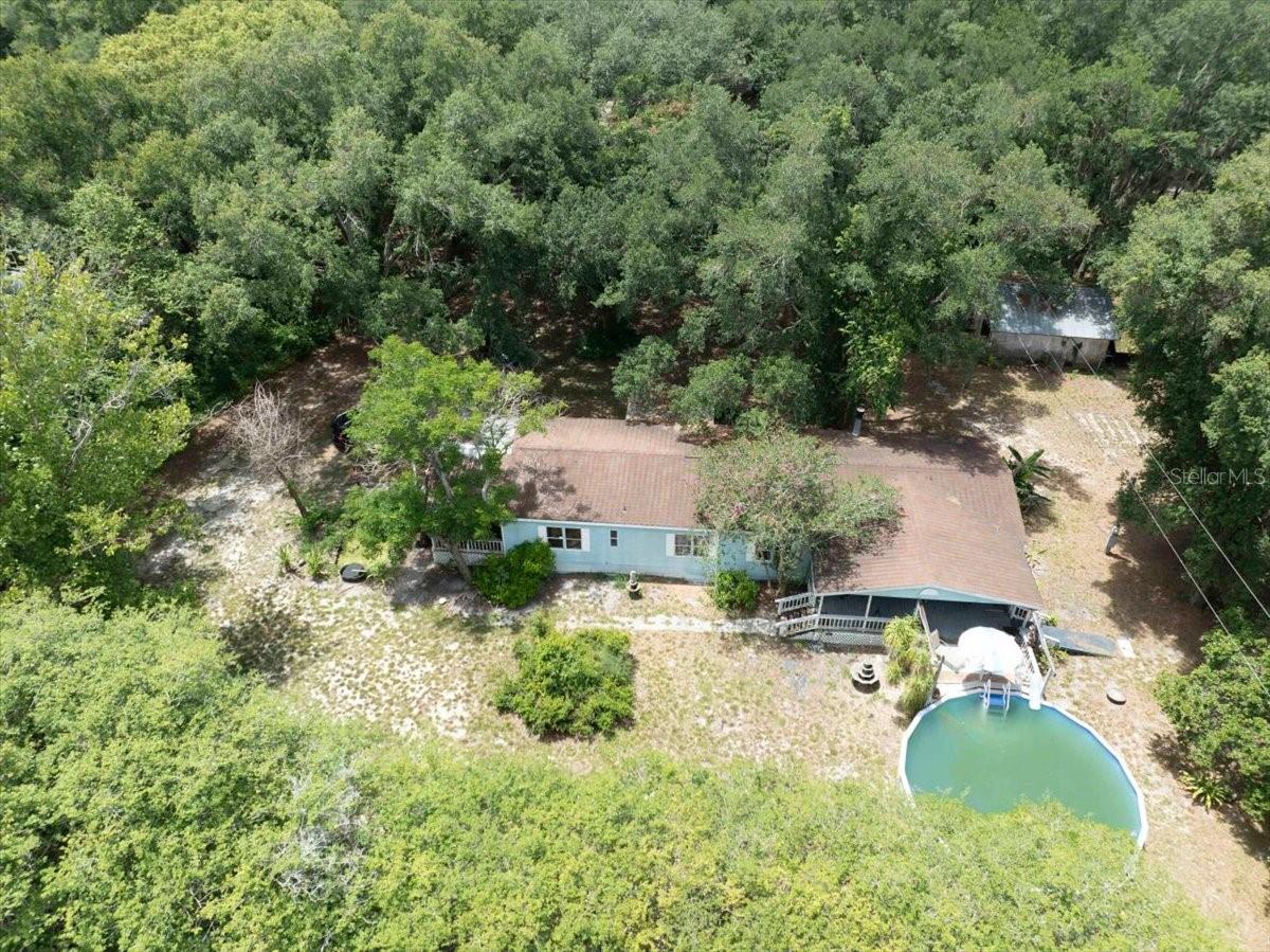 Looking for privacy, acreage, workspace, and room for more than one household? This unique offering includes two adjoining properties that must be sold together, providing a combined 5.2 acres, two manufactured homes, and a large detached block building in north Lakeland with no current flood zones or history of flooding. The front parcel features a 1994 doublewide manufactured home along with an oversized workshop that offers plenty of space for vehicles, equipment, storage, projects, or a home-based business. The second parcel, located behind the front property, includes another 1994 manufactured home, creating a setup that could work well for extended family, guests, caretakers, rental income opportunities, or anyone who simply appreciates having additional living space separate from the main residence. Both homes need updating and improvements but offer a solid starting point for buyers willing to invest some time and effort. The property's layout, acreage, and existing structures provide a variety of options that are increasingly difficult to find in today's market.With more than five acres across two separate parcels, there is plenty of room for gardening, recreation, equipment storage, animals where permitted, or simply enjoying additional privacy and open space. The large workshop is a standout feature and adds flexibility for hobbyists, tradespeople, small business owners, or anyone needing substantial workspace. CASH BUYERS ONLY. The two parcels are being sold together and will not be sold separately. If you've been searching for a property with land, multiple residences, and a workshop, this may be the opportunity you've been waiting for.