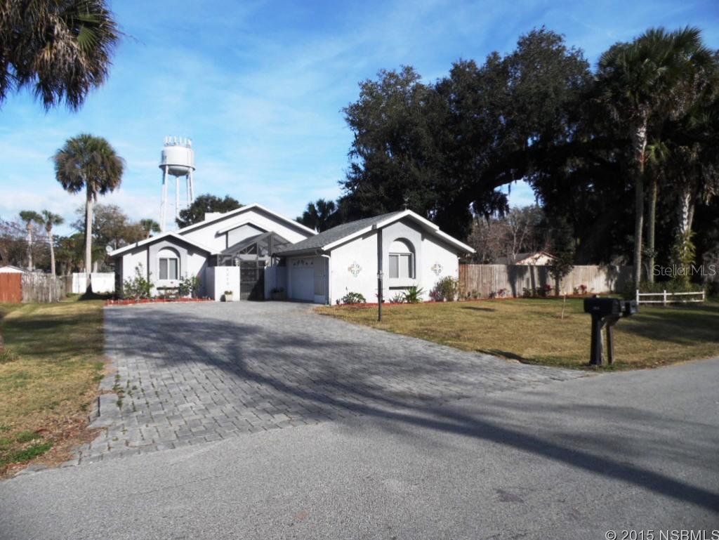 Located on a triple lot, this property features a very large paver stone driveway. With pavers that extend into the completely screened front courtyard. Open up the set of double doors and enjoy the mild Florida winter. Over 2,000 sq.ft. of living space with 3 large bedrooms, 2 full baths and one half bath. Master bath has separate shower, large tub and wide vanity with dual sinks. Step into the large living room with high vaulted ceilings and skylights that provide plenty of natural light. The grand fireplace adds to the unique charm of this home and the formal dining room is perfect for family dinners. Bring all the toys. There is plenty of parking in the massive driveway and a 16 foot gate provides entry to the completely fenced backyard. All of this located just minutes to some of the best boating and fishing the state has to offer. ;Water: City
