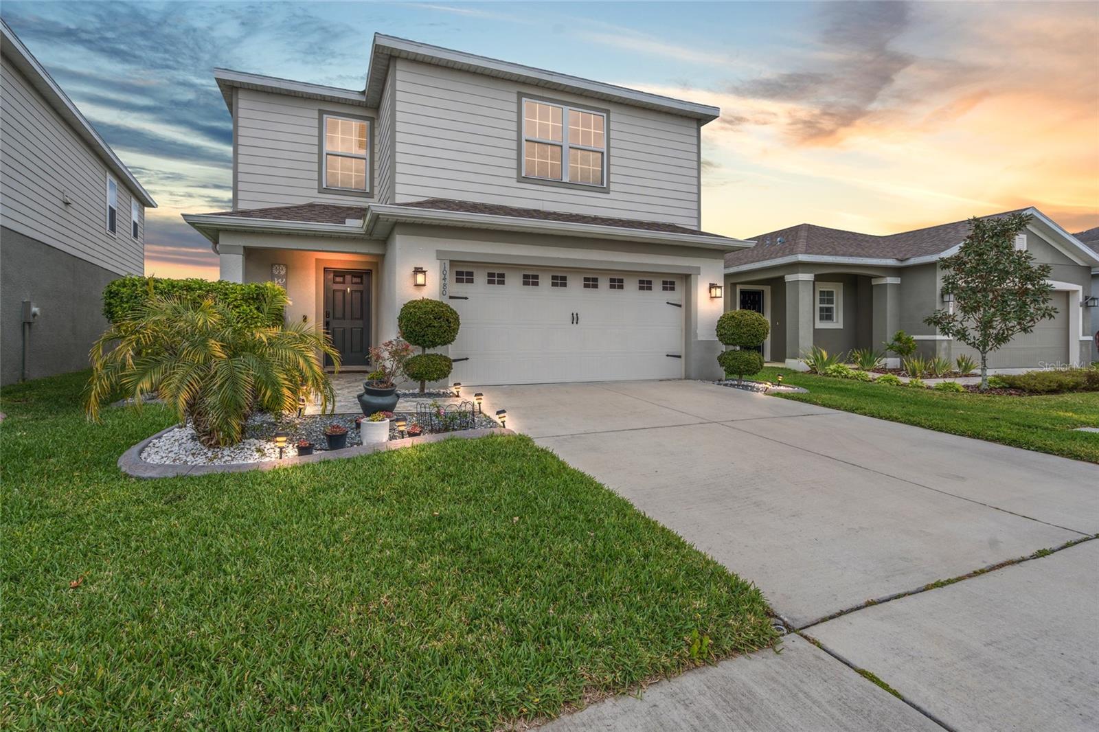 Welcome to this beautifully upgraded 4-bedroom, 2.5-bath home in the highly desirable Cypress Preserve community of Land O’ Lakes. Built in 2019, this move-in-ready two-story residence offers over 2,100 square feet of thoughtfully designed living space with stylish updates throughout. From the moment you arrive, you’ll notice the enhanced curb appeal featuring custom landscaping with decorative stone design, concrete landscape borders, updated front entry stone tile, gutters, and a fenced backyard accented with solar lighting. Inside, the home has been refreshed with interior paint and upgraded flooring throughout, including high-traffic, scratch-resistant vinyl plank flooring replacing all carpet for a modern, low-maintenance finish. The open-concept layout is ideal for everyday living and entertaining, with spacious living and dining areas enhanced by a custom wood accent wall and upgraded lighting. The kitchen has been improved with a newer dishwasher, updated sink, and modern faucet. Upstairs, all bedrooms are privately situated, including additional upgrades such as a newly installed ceiling fan and wiring in one bedroom that was not originally provided by the builder. Bathrooms have been tastefully renovated, including a fully upgraded upstairs hall bath with tile finishes, tempered glass shower doors, and updated fixtures, plus an updated downstairs half bath with a new vanity and faucets. Step outside to your own private backyard retreat featuring an extended lanai complete with pergola, lighting, concrete extension, stone tile finishes, and a screened-in covered patio—perfect for relaxing or hosting guests year-round. Enjoy peaceful conservation and pond views with no rear neighbors, creating a serene setting rarely found. The backyard’s southwest exposure offers stunning sunset views each evening, making it the perfect place to unwind after a long day. Additional features include solar panels for improved energy efficiency and custom heavy-duty wood shelving in the garage for extra storage. Located just minutes from the Suncoast Parkway, this home offers convenient access to Tampa, top-rated schools, shopping, dining, and entertainment. Enjoy nearby favorites like Stonewater Grill, The Breakfast Nook, Publix Super Market at Shoppes at Sunlake Centre, and Tampa Premium Outlets. Outdoor enthusiasts will love nearby Conner Preserve with trails, nature, and recreation. Land O’ Lakes continues to experience strong residential and commercial growth, making this an excellent opportunity for homeowners and investors alike. This home combines comfort, upgrades, location, and breathtaking views in one exceptional package.