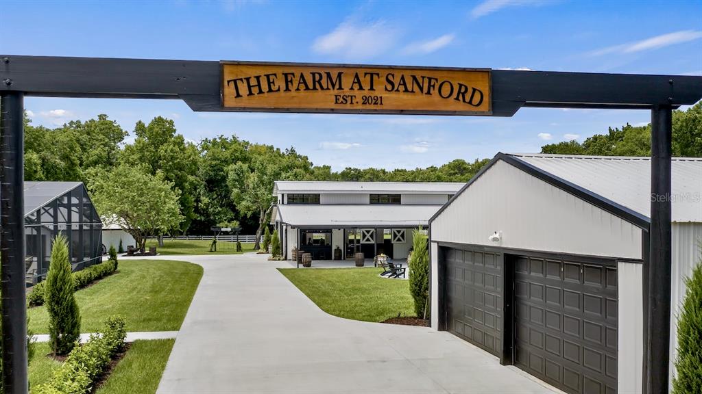 The Farm at Sanford is a ‘one-of-a-kind’ property covering almost 14-acres near the St. Johns River in Seminole County. The grand scale of the property is apparent upon entering the compound, yet once inside, there is a sense of peace and tranquility brought on by the sheer magnitude of the space, the meticulously manicured grounds, mature oak trees, two fire pits with ample seating, sparkling ponds with fountains and perimeter fencing. 

The sprawling 3000+ square foot Farmhouse has a rustic, yet sophisticated feeling with three bedrooms, 2 bathrooms and spacious living areas. The chef’s kitchen features high end stainless steel appliances that will inspire fabulous meals in the formal dining room. The family room enfolds to the bonus room and out to the oversized lanai with outdoor lounging area. The screened sparkling pool features ample area for catching the rays or relaxing in the shade - enjoy a permanent “staycation” at the farm. The opportunities are endless. The main home includes an attached 2 car garage and sprawling front porch that makes you feel at home.


The 1000+ square foot Guest House features a spacious open floor plan with full kitchen, two bedrooms and 2 bathrooms. There are two separate oversized 1 car garage bays, one includes a washer/dryer and comes complete with a catering prep area. The guest house structure includes a bonus/game room and separate access to his and her restrooms for events.


The showcase of the farm is the elegant 3600 square foot barn with large attached undercover patio that his been transformed into the perfect place to host events or continue to develop a burgeoning destination wedding business. The vintage Ford truck shown in the photos and video conveys with the property along with the tractor. The barn includes all of the furnishings, cabana bar and hi-tech audio video system.  Adjacent to the barn is another oversized storage garage for farm toys and storage. 

Additional property features include: in-ground trampoline, tree swings, paver areas for entertaining/dancing, parking area with lighting, irrigation well and acres of pasture. The Farm is less than 30 minutes to Downtown Orlando and 45 minutes from the beaches.