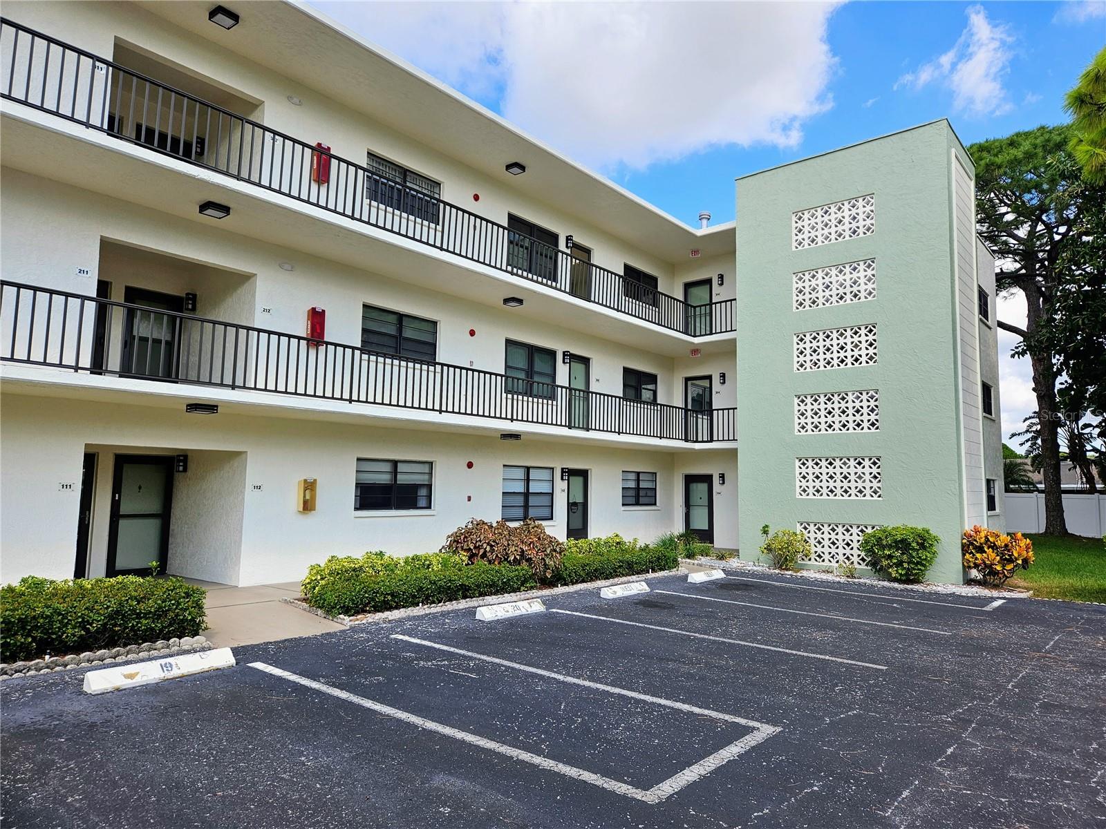 Come see this beautifully remodeled CORNER UNIT on top floor of the Shoreview East Building in popular 55+ Five Towns community (one of few buildings where you can have two pets under 35 lbs!). This condo has a very spacious open floorplan with luxury vinyl plank flooring throughout the two bedroom/two bath unit. The unit has just been freshly repainted throughout in neutral color to suit any decor. The large Great Room has an open Kitchen concept and handsome Kitchen has soft grey cabinets, solid surface counters and stainless steel appliances including French door style refrigerator, built-in microwave, gas range, dishwasher and oversized deep sink. There is a huge central island with lots of storage and seating. Sliding doors off Living Room lead to screened balcony overlooking peaceful pond view. New contemporary lighting, fans, fixtures and closet doors throughout. The spacious Master Bedroom will accommodate a king-sized bed, has a spacious walk-in closet and private ensuite Bathroom. Enjoy the renovated Master Bathroom with new vanity, fixtures, lighting and walk-in shower with glass sliding doors. This unit has a laundry room and includes full size washer and dryer for your convenience. The building also has a community laundry room on the second floor for oversized laundry needs, elevator in main entry lobby and your own storage cubby. The unit has a glass storm door and keyless coded lock. Condo comes with a carport which is a feature many units at Five Towns do not have. Five Towns has six swimming pools, nine peaceful ponds, two community clubhouses with large event room, billiards room, card room, library, and two fitness centers. Enjoy the walking trails, tennis courts, shuffleboard courts, bocce ball courts and one of several outdoor picnic and grilling areas. If you want to participate in social events, there are many always happening including card games, dances, painting, yoga, swimming, band concerts, quilting and more. Your monthly fees include water, sewer, garbage pickup, basic cable TV, exterior maintenance, property management and natural gas costs for your heating and cooking.