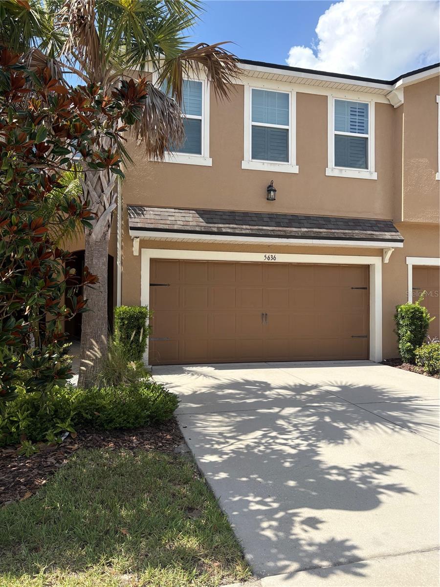 Available July 20th, this well-maintained 3-bedroom, 2.5-bath townhome with a two-car garage offers a functional, open layout, clean modern finishes, and a peaceful pond view, plus water included in the monthly rent. The first floor is designed for effortless everyday living, with an open-concept layout that connects the kitchen, dining, and living areas. The kitchen blends style and practicality, featuring stainless steel appliances, beautiful cabinetry, granite countertops, a decorative backsplash, a pot filler, and a large island with bar seating. Plank tile flooring runs throughout the main level, while a conveniently located half bath sits just off the main living space. Sliding glass doors lead to a screened-in porch with paver flooring, creating a private outdoor setting overlooking the pond. Upstairs, a spacious loft provides flexibility for a second living area, home office, or media space, separating the primary suite from the additional bedrooms. The primary suite includes two walk-in closets and a private bath with dual vanities, a walk-in shower, and a linen closet. The two additional bedrooms each feature walk-in closets and share a full bathroom with dual sinks. A dedicated laundry room is also located on the second floor for added convenience. An electric car charger in the garage adds everyday functionality. The home is located in a gated community with a highly sought-after school district with top-rated schools. The community also features amenities such as a resort style pool and a park. Just minutes from shopping, dining, and major roadways including the Veterans Expressway, this property offers a well-balanced combination of comfort, convenience, and location.