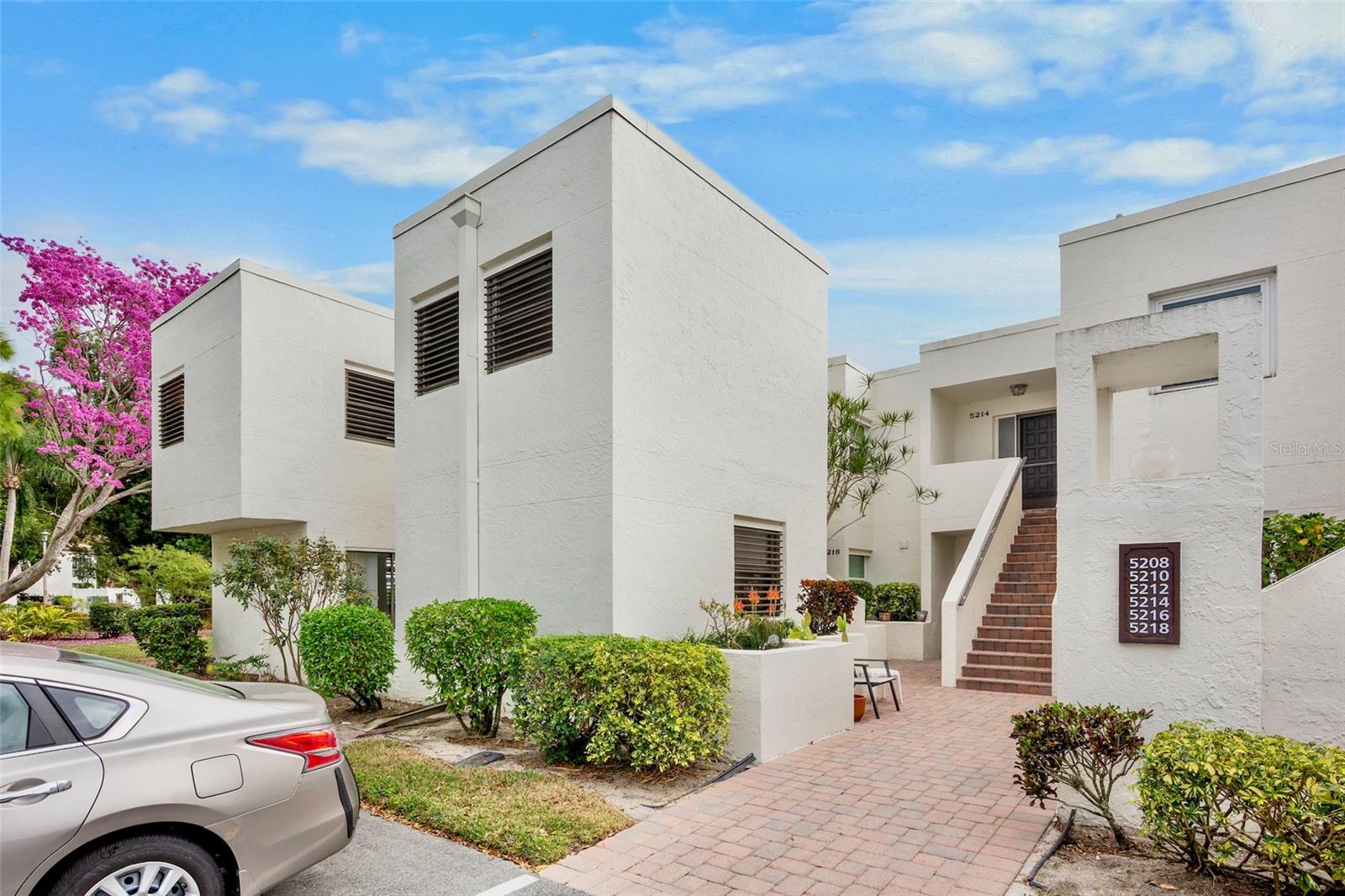 LARGEST 2 BDR CONDO IN THE MEADOWS! Your new home in Heronmere II sits in the heart of The Meadows- a quiet enclave centrally located in Sarasota- where it's happening. Created by renowned architect Tim Siebert of the Sarasota School of Architecture, the design features clean lines, separation of living and sleeping space and an abundance of natural light. This rarely available end unit, just shy of 1600 square feet under air can be yours- TURN-KEY FURNISHED! Large square cut ceramic tile is installed throughout, including on the "HURRICANE IMPACT" glassed-in lanai overlooking the lake and golf course. Recent kitchen renovations include Stainless appliances, a raised ceiling with recessed LED lighting and granite countertops. All windows in the unit have been replaced and each window has built-in adjustable storm shutters for your protection. Your carport is immediately out front, but you’re close enough to the Meadows Village and its restaurants that you’ll probably decide to walk. The Meadows is located 15 minutes from downtown Sarasota. Here you'll have access to miles of walking/biking trails, The Meadows 18 hole golf course, a new state-of-the-art fitness center, pickle ball and tennis courts, a dog park and much more. Some of the country's most beautiful beaches are nearby, as well as world-class arts and culture, restaurants, entertainment and shopping. You are just a short drive to Nathan Benderson Park with its beautiful 400 acre lake, and just 2 miles from the regional shopping mall at University Town Center. THIS is the Sarasota lifestyle!