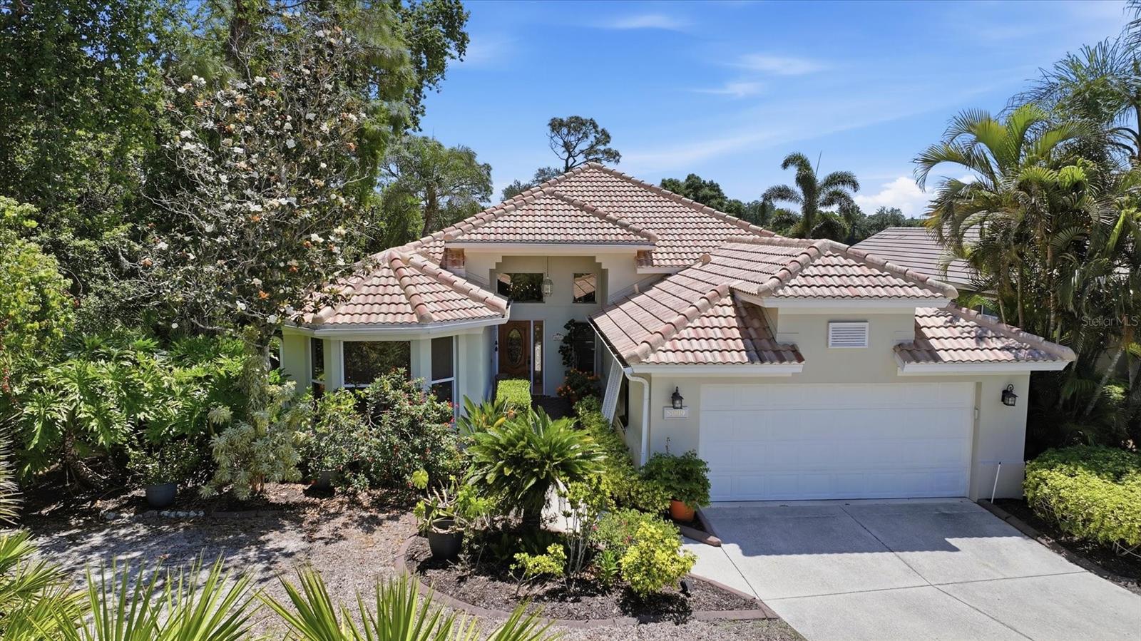 Tucked within the award-winning University Park Country Club, this beautifully maintained, move-in-ready residence offers 3 bedrooms,
2.5 baths and an exceptional blend of comfort, style, and functionality. From the moment you arrive, lush tropical landscaping, a spacious homesite, and an elegant wood-and-glass entry door with transom and sidelights create a warm and inviting first impression.
Inside, the light-filled open-concept living and dining areas feature soaring ceilings, recessed lighting, and ceiling fans, creating an airy and welcoming ambiance. The thoughtfully designed floor plan offers flexibility, with a spacious living area showcasing a custom multi-function built-in, and an adjacent space currently used as a sitting area that can easily transition into a formal dining room. Expansive fully retractable triple sliding glass doors seamlessly extend the living space to the outdoors.
The chef’s kitchen is both stylish and functional, featuring a gas range, quartz countertops, newer appliances, a pantry closet, abundant cabinetry, and recessed lighting. A breakfast bar, charming window seat, and generous windows complete the space, making it perfect for both everyday living and entertaining. The adjacent laundry room offers added convenience with a washer and dryer, utility sink, and storage cabinets.
Just off the main living area, a private office or study with built-in desk and bookshelves provides exceptional versatility, complete with a queen Murphy bed and custom cabinetry—ideal for use as a guest room or additional bedroom.
The primary suite is a tranquil retreat, featuring a sitting area, multiple windows, and retractable double sliders that open to the lanai. The ensuite bath offers dual sinks, a dedicated makeup vanity, a garden tub, a zero-entry walk-in shower, and a spacious walk-in closet with extensive built-ins. The guest bedroom is bright and welcoming, with easy access to a full bath with a tub/shower combination.
Outdoor living is equally impressive. The covered, screened lanai is designed for relaxation and entertaining and includes a convenient half bath. Beyond, a beautifully pavered circular patio with a firepit provides the perfect setting to enjoy serene views of the 17th fairway and lush tropical surroundings, complete with a retractable sun awning for added comfort.
Peace of mind is assured with major updates already completed, including a NEW ROOF (2021), HVAC system (2020), and tankless water heater.
Located in the maintenance-free Hampton Green neighborhood, residents enjoy access to a community pool and a truly carefree lifestyle, all within one of the area’s most sought-after communities.

University Park Country Club is consistently ranked one of the top courses in Florida featuring 27 holes of championship golf; tennis and pickleball; fitness center, croquet – as well as an array of social and group activities.  Just a 15-minute drive outside this peaceful enclave is downtown Sarasota, with shopping, arts & theatres, museums, dining and entertainment, top-ranked healthcare, beaches and SRQ International Airport.  Two miles east of UPCC is the convenience of I-75, University Town Center with over 300 nationally known and homegrown shops, restaurants, fitness studios, services and attractions, the Nate Benderson Park, home of world-class rowing events and the Mote Marine Aquarium.
Enjoy the club amenities with the required minimum of a Social membership at UPCC.