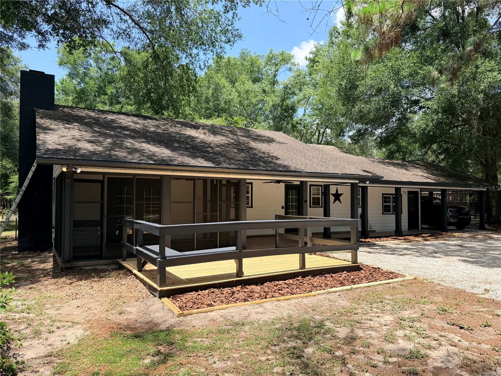 Renovated and move-in ready! Nestled on a beautiful 1-acre lot shaded by mature trees, this charming home offers the perfect blend of peaceful country living and modern updates, all with a High Springs address but without Alachua County taxes.

Located just minutes from Ginnie Springs you'll enjoy easy access to crystal-clear 72-degree spring water year-round for swimming, snorkeling, kayaking, paddleboarding, scuba diving, tubing, and camping along the beautiful Santa Fe River. Living this close means weekends can be spent on the water instead of in the car, making this an ideal location for outdoor enthusiasts, second-home owners, or anyone seeking the laid-back North Florida springs lifestyle. Previously operated as a highly successful Airbnb, it offers excellent short-term rental potential.

Inside, you'll find a beautifully updated kitchen featuring new quartz countertops, an undermount sink, and brand-new, never used, stainless steel appliances. Additional recent improvements include a completely new HVAC system, fresh interior paintwork, and numerous exterior updates.

Enjoy the outdoors from the spacious open front porch, newly renovated wood deck, or the screened front and rear porches with new screening. The exterior has just been professionally power washed and features freshly completed architectural paint on the soffits, fascia, and trim, providing outstanding curb appeal.

Outside, the property includes an RV electrical hookup, a pole barn large enough for a boat or vehicle, and plenty of room to enjoy the privacy and beauty of the surrounding landscape.

Whether you're looking for a peaceful family home, a vacation retreat near Florida's world-famous springs, or an income-producing investment, this property checks all the boxes. Convenient to downtown High Springs and an easy drive to Gainesville, you'll enjoy the best of North Florida living with recreation, shopping, dining, and everyday conveniences all within reach.