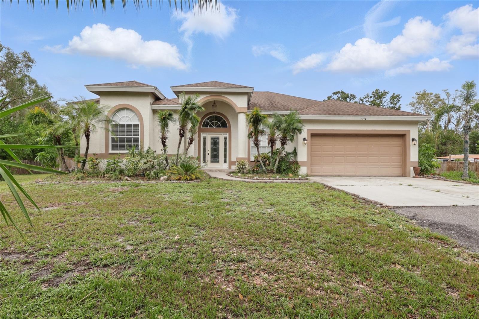 Rarely Available! This spacious and beautifully maintained property offers a unique blend of comfort, versatility, and opportunity, all situated on a fully fenced 1.46-acre lot with no deed restrictions — bring your boat, RV, and all your toys! The main residence, built just six years ago, features over 2,750 square feet of living space with 4 bedrooms, 3 bathrooms, a formal dining room, both living and family rooms, tray ceilings, and an inviting open floor plan. The home also includes a large kitchen with pantry, a high columned entry foyer, porcelain tile floors throughout, and a cozy fireplace in the family room. The spacious primary suite boasts two walk-in closets and a generous bathroom. Enjoy outdoor living with a covered lanai and plenty of room to create your dream garden, build a pool, or add other amenities. In addition to the main home, there is a 1-bedroom, 1-bath guest house with soaring 9+ foot ceilings, ideal for extended family, guests, or potential rental income. The L-shaped lot features mature trees, 97 feet of access on the side street for easy entry, and ample parking space. Located just minutes from University Parkway, Rolling Green Golf Course, and SRQ Airport, this is the perfect blend of privacy and convenience. Central water and sewer in place. A rare find with plenty of room to roam!