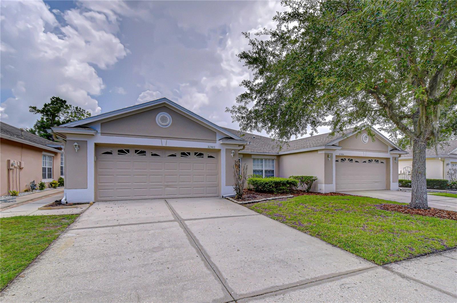 Welcome to this beautifully maintained, maintenance-free villa located in the gated Whitlock Village community of Meadow Pointe. This spacious 3-bedroom, 2-bath (3rd room can be a Den or office)and 2-car garage offers 1,551 square feet of comfortable living space with a desirable split-bedroom floor plan and an open, airy layout.

Step inside to a bright great room filled with natural light, enhanced by wood laminate flooring and easy access to the screened, covered lanai with added privacy from the vinyl fencing. The primary suite is privately positioned off the main living area and features walk-in closets and an en-suite bathroom with dual sinks, a soaking tub, and a separate enclosed shower.

The kitchen offers generous cabinet storage, a pantry closet, a breakfast area, and a raised bar overlooking the great room, making it easy to stay connected while cooking or entertaining. A convenient indoor laundry area is tucked behind folding doors within the kitchen space.

The den/office, accessed through double doors, provides flexibility for a home office, hobby room, or additional guest space. The secondary bedroom is located toward the rear of the villa, offering privacy from the main living areas. The attached two-car garage is accessible through the interior hallway for everyday convenience.

Recent updates include Roof 2021, Norandex windows with Energy Star and energy performance ratings 2021.The HOA provides exterior maintenance, including landscaping, lawn irrigation, and exterior painting, allowing for a truly low-maintenance lifestyle.

Residents of Meadow Pointe enjoy access to community amenities including a pool, fitness center, tennis courts, clubhouse, playground, and more. Conveniently located near major highways, The Shops at Wiregrass, Tampa Premium Outlets, restaurants, medical facilities, and everyday shopping.