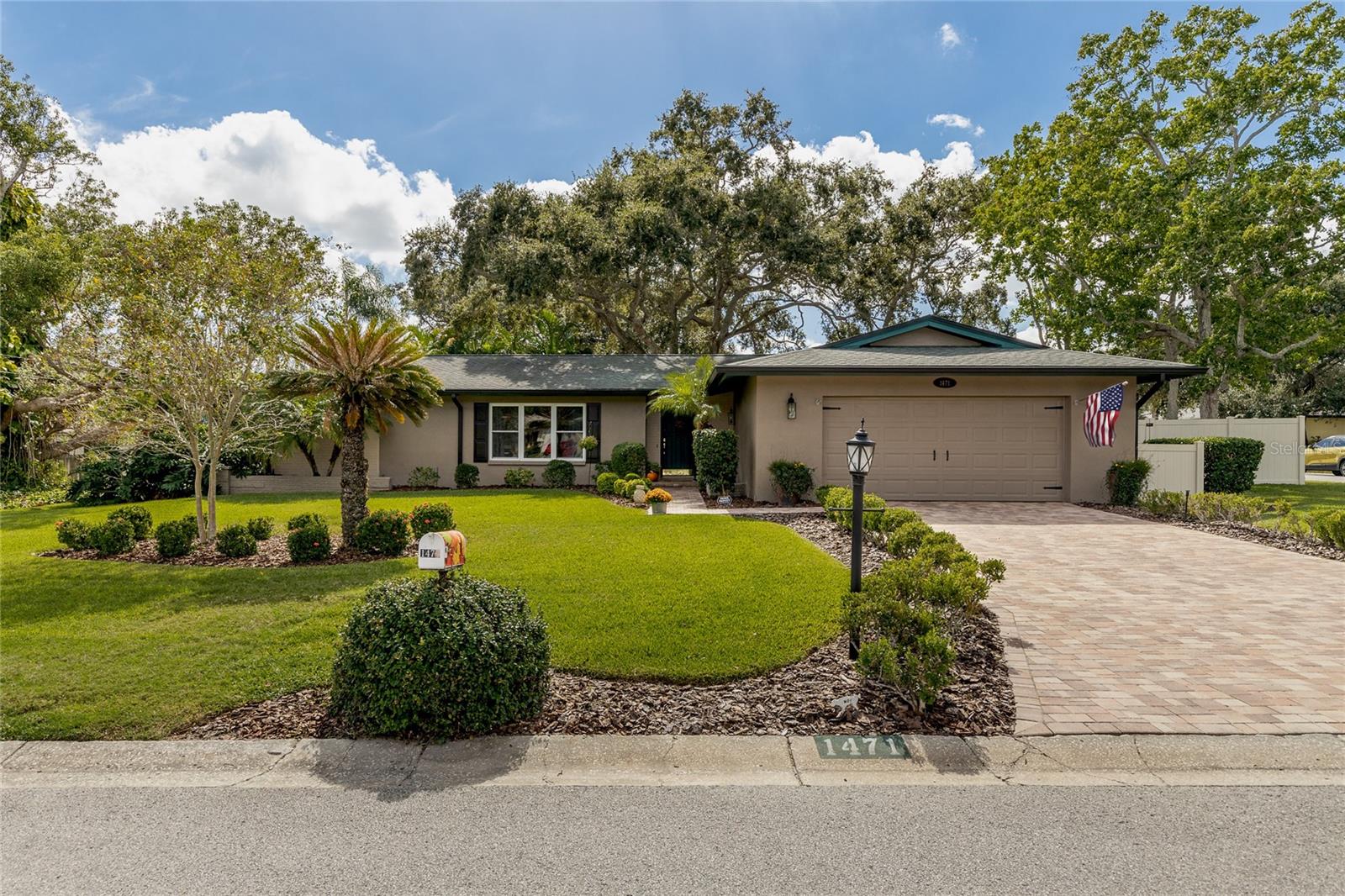 Welcome to 1471 Fairway Drive.     This REMARKABLE home has been meticulously and lovingly maintained by the same owners for 33 years!   A beautiful paver driveway and walkway lead you to the front door.    Upon entry you will feel the warmth and hominess in every room!   The Living Room has a huge window offering a beautiful view to your front yard.     High-end Laminate wood flooring runs thru most of this home.     Spacious Double Master Suites on opposite ends of the home offering plenty of privacy.   In 2018 the Kitchen was refreshed with Marble counters and a gorgeous backsplash.     The Guest Bathroom was fully remodeled in 2021 and the Master Bathroom was refreshed this year.   Do you appreciate POCKET DOORS?   This home has FIVE!!!       At the back of the home is a 270 sq. ft. porch that extends the living space, at first glance you might not realize you aren’t in the heated and cooled part of the house!   New vinyl windows were added to this space in 2022.     The Heated Pool with a Salt Water Chlorination system, spa (complete with pop-up cleaners) and screened/covered lanai are so serene and you will truly enjoy morning coffee here or winding down at the end of the day perhaps with a glass of wine!    This home is situated on a HUGE corner lot (.30 acres) with plenty of space in the back yard for planting a garden or for pets and playsets!    Brand new PVC fencing was installed this year.     Need storage?    This home has tons of closet space inside, and the OVERSIZED garage offers even more space for storage or workshop areas.    The current owner is a classic car fan and really appreciated the space in the garage.    The Roof and Gutters were replaced in 2016, HVAC (Heat pump) 2019, Windows 2020, Pool Heater and Salt Chlorination systems updated in 2022.     Fairway Estates is a highly sought after Golf Cart accessible community.    Flanked on 2 sides by the Dunedin Golf Club, if you enjoy golf you will love living here!     Designed by Donald Ross the course was once the home of the PGA.   At the HEART of this community is Lake Saundra and the community owned park.    Residents gather at the park throughout the year to relax by the lake and watch the many critters that come to frolic in the lake and on the banks.    If you love the beach then this is perfect as you are just a few short miles to award winning Honeymoon and Caladesi Island state parks.    You will also appreciate how close you are to the Pinellas Trail, Highlander and Hammock Parks as well as the Community and Fine Arts Center.    Hop on your golf cart and take the short ride to downtown Dunedin with all of the fabulous restaurants, shops, breweries and bars!     Don’t miss your chance to tour this home!   Kitchen Island does not convey.