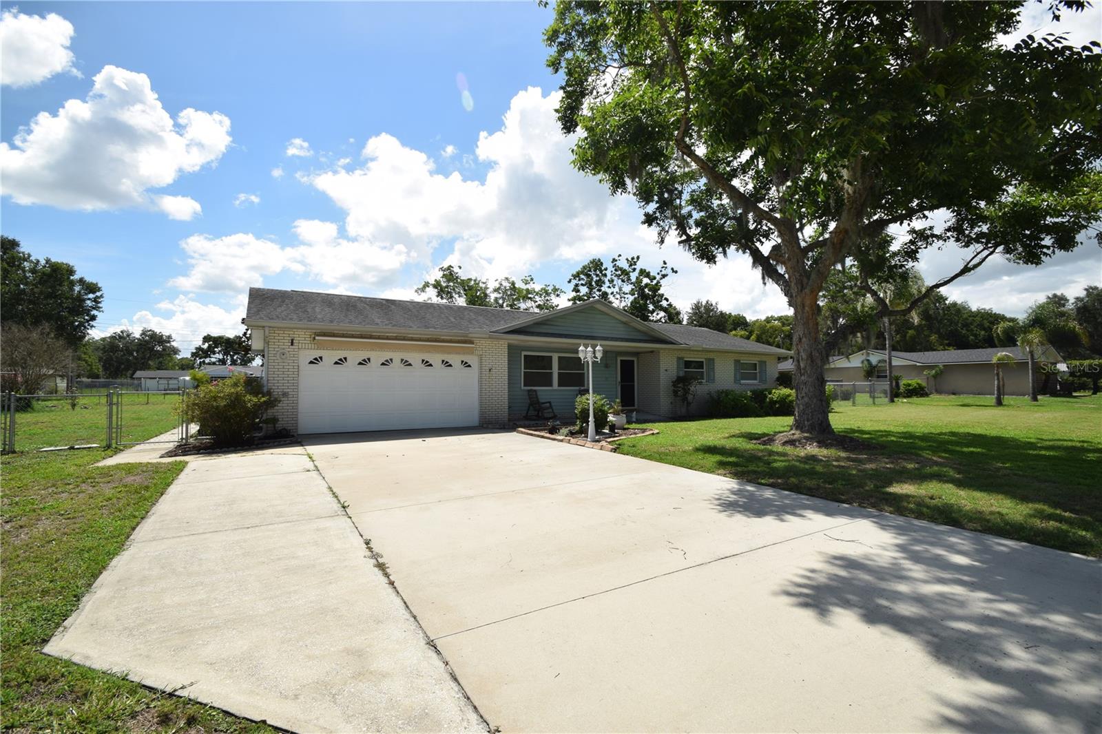 Welcome to 6739 Farris Drive in desirable South Lakeland! This well-maintained concrete block home sits on an impressive 0.65-acre lot with no HOA, giving you extra space, flexibility, and freedom to enjoy your property your way. Located in an established South Lakeland neighborhood and within minutes from the LAKELAND AIRPORT, this home offers convenient access to shopping, dining, area schools, and major routes connecting you to both Tampa and Orlando. Inside, you’ll find a comfortable and functional layout featuring a spacious kitchen with abundant wood cabinetry, along with separate living and dining areas that provide plenty of room for everyday living and entertaining. One of the standout features of this property is the whole-house Generac generator with large-capacity propane tanks, providing peace of mind and the ability to power the entire home during outages. The fully fenced backyard offers exceptional outdoor space and includes two large storage sheds with electricity, perfect for tools, hobbies, equipment, or additional workspace.

You’ll also love the oversized 31 x 15 enclosed rear porch with vinyl windows, creating a wonderful year-round space to relax, entertain guests, or simply enjoy views of the large backyard. The garage is equipped with a retractable awning and screen, adding even more usable living and gathering space.  Move-in ready and packed with practical upgrades, this South Lakeland home offers the rare combination of location, land, no HOA, storage, and peace-of-mind features. Well-priced homes on large lots in South Lakeland are hard to find—schedule your private showing today before this one is gone!