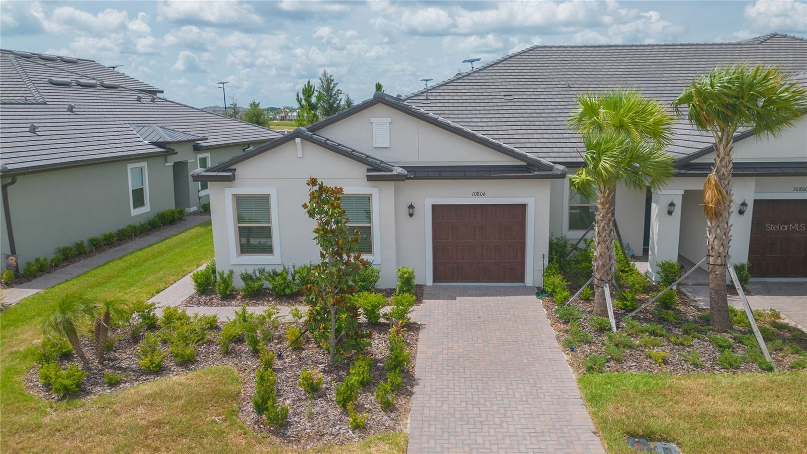 Step into resort-style 55+ living in Medley at Mirada, where this 2024-built villa pairs a bright, open layout with low-maintenance comfort and access to one of Tampa Bay’s most exciting lagoon communities.

Welcome to 10806 Gable Dig Loop, a beautifully kept 2-bedroom plus office/flex room, 2-bath home offering 1,625 heated sq ft of thoughtfully designed living space. From the curb, the home features a clean modern exterior, tile roof, paver driveway, tropical landscaping, and an inviting single-story layout. Inside, you’ll find an open-concept great room with abundant natural light, neutral finishes, wood-look tile flooring through the main living areas, and a comfortable flow between the dining area, living room, kitchen, and screened lanai.

The kitchen is bright and functional with white cabinetry, quartz-style countertops, stainless steel appliances, recessed lighting, a subway tile backsplash, pantry storage, and a large island with seating. The living and dining areas offer flexible space for everyday comfort or entertaining, while sliding glass doors connect the main living area to the screened lanai with pavers, creating an easy indoor/outdoor extension for morning coffee, evening relaxation, or casual gatherings.

The private primary suite offers generous space, a walk-in closet, and a clean, modern bathroom with dual sinks, white cabinetry, a glass-enclosed walk-in shower, and neutral finishes. A secondary bedroom, full guest bathroom, and separate office/flex room provide options for guests, hobbies, work-from-home needs, or additional storage. The interior laundry room and finished garage add practical convenience.

Located in Medley at Mirada, Lennar’s 55+ active adult community, residents enjoy a low-maintenance lifestyle with HOA-included cable, internet, lawn care, common grounds maintenance, and exterior maintenance items including paint and roof coverage. Medley amenities include a clubhouse, fitness center, pool, pickleball, bocce, tennis, trails, dog park, and a full calendar of events. Residents also enjoy access to Mirada’s 15-acre lagoon lifestyle, featuring sandy beach areas, swim areas, kayaking, paddle boarding, water slides, volleyball, splash zone, obstacle course, events, and more.

This location places you close to everyday conveniences and regional destinations. Approximate drive times include 5–10 minutes to Publix and nearby shopping at Mirada/Innovation Springs, 10 minutes to I-75, 20–25 minutes to KRATE at The Grove, 25–30 minutes to Tampa Premium Outlets and The Shops at Wiregrass, about 45–50 minutes to Tampa International Airport, and roughly 40–50 minutes to Downtown Tampa depending on traffic.

Built in 2024 with concrete block/stucco construction, a tile roof, modern systems, and HOA-supported exterior maintenance, this home offers buyers confidence, value, and a move-in-ready alternative to builder inventory. Schedule your private showing today and experience the comfort, convenience, and lifestyle of Medley at Mirada.