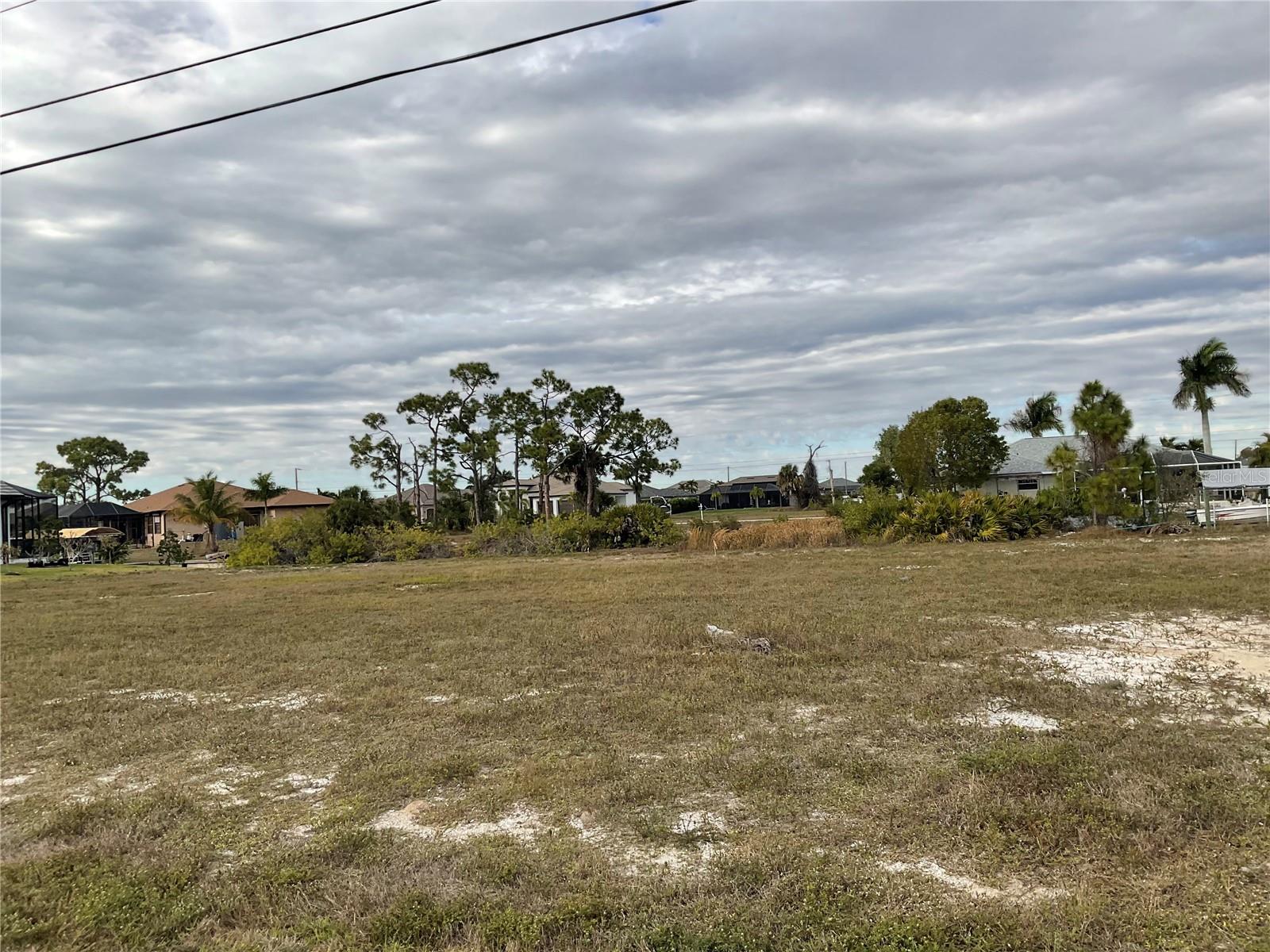 Vacant waterfront lot in a quiet NW Cape Coral neighborhood.  An exceptional opportunity to create a custom luxury residence on this desirable waterfront homesite. Set on a peaceful canal in an area of newer homes, this lot offers the perfect canvas for refined coastal living, outdoor entertaining, and serene water views. Enjoy privacy, sunshine, and convenient access to Fort Myers, beaches, dining, and shopping while designing a home that reflects the ultimate Southwest Florida lifestyle.
