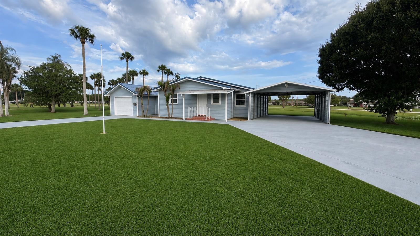 Welcome to your private waterfront retreat in Okeechobee, where peaceful canal living meets comfort, functionality, and true Florida lifestyle.

This beautifully maintained property offers direct water access with multiple covered boat docks, making it the perfect escape for boating, fishing, and outdoor enthusiasts. From the moment you arrive, you’ll appreciate the pride of ownership, charming coastal-inspired exterior, metal roof, and detached oversized garage ideal for storing boats, toys, tools, or creating the ultimate workshop space.

Inside, the home features an open-concept layout filled with natural light, neutral finishes, crown molding, and spacious living areas designed for both relaxation and entertaining. The kitchen opens seamlessly into the dining and family room, creating a warm and inviting atmosphere for gatherings with family and friends.

The primary suite offers a cozy coastal feel with generous space, while the large bathroom includes dual vanities, a walk-in shower, and abundant storage. Additional flex spaces and enclosed porch areas provide endless possibilities for a game room, hobby room, office, or additional entertaining area overlooking the water.

Step outside and experience true Old Florida living with expansive canal views, covered sitting areas, screened spaces, and private docks ready for your next sunset cruise or fishing adventure. Whether you’re looking for a seasonal getaway, full-time residence, fisherman’s paradise, or investment opportunity, this unique waterfront property delivers the lifestyle people move to Florida for.

Enjoy privacy, space, waterfront access, and unforgettable sunsets — all while being conveniently located near local marinas, dining, shopping, and the natural beauty that makes Okeechobee so special. 
This property includes a powerful 22kW Generac standby generator designed to provide back up power during electrical outages.
