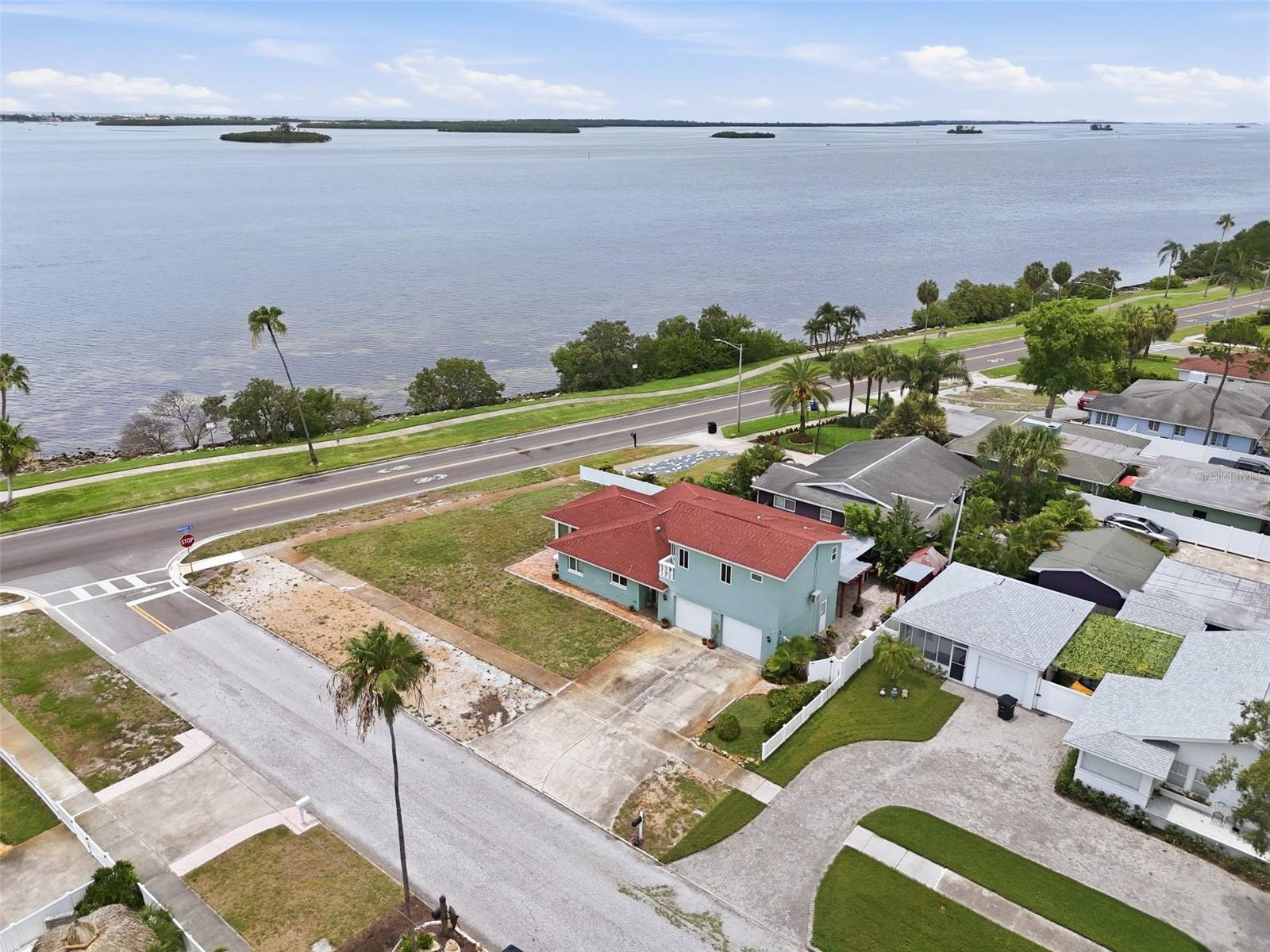 Welcome to a truly exceptional residence where timeless Florida charm meets modern luxury. Perfectly positioned on a spacious corner lot, this beautifully updated two-story home offers an elevated lifestyle with stunning water views and direct access to Clearwater Harbor. Designed for both entertaining and everyday comfort, every detail has been thoughtfully curated to create a home that feels as impressive as it is inviting. 
Step inside to discover soaring ceilings, rich wood flooring, elegant crown molding, and an abundance of natural light that fills the open living spaces. The heart of the home is the beautifully appointed kitchen, featuring solid wood cabinetry, stone countertops, and a seamless flow into the living and gathering areas, creating the perfect setting for hosting family and friends.
With three spacious bedrooms, each offering ensuite bath access, privacy and comfort are built into every corner of the home. The luxurious primary suite serves as a private retreat, complete with a spa-inspired bathroom featuring dual vanities, a clawfoot soaking tub, oversized shower, and walk-in closet. Flexible living spaces, including a charming Florida room, provide endless opportunities for relaxation, work, or entertaining.
Outside, the lifestyle truly comes to life. Enjoy peaceful mornings and spectacular sunsets from the covered porch, private courtyard, patio, or gazebo. The fenced yard offers both privacy and functionality while showcasing beautiful water views that remind you daily why Florida living is so special.
Additional highlights include a two-car attached garage, double-pane windows, central air, and a thoughtfully designed floor plan that balances elegance with everyday practicality. Whether you're entertaining guests, enjoying quiet evenings outdoors, or simply taking in the coastal atmosphere, this home delivers a rare combination of luxury, comfort, and location.
This is more than a home—it's an opportunity to embrace the waterfront lifestyle you've been dreaming about.