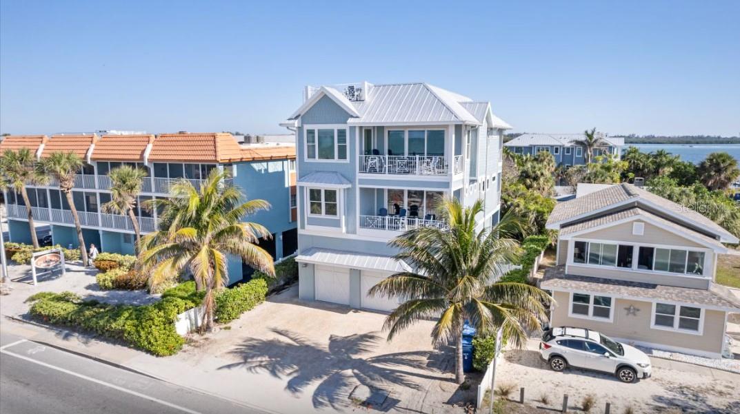 Welcome to Summer Sunset, the epitome of luxury living on the Gulf of Mexico. This stunning new property offers unparalleled views of the pristine blue waters, now completely unobstructed thanks to recent beachside enhancements. Imagine gazing at the breathtaking Gulf and Bay from multiple balconies or the expansive rooftop deck—each moment here is unforgettable. Inside, you'll find a beautifully designed six-bedroom, six-and-a-half-bathroom haven, adorned with high-end furnishings and intricate details. Dive into your private heated pool and spa, or enjoy a game of foosball before catching your favorite show on the TVs available in every room and even on the poolside porch. With en-suite bathrooms in every bedroom, convenience and privacy are guaranteed. The open-plan kitchen seamlessly merges with the living and dining areas, fostering an inviting atmosphere for entertaining. Choosing between a beach day or poolside relaxation? At Summer Sunset, you don’t have to. Step into the sunlit pool or take a short stroll across the street to the beach, where the water is as blue as you've dreamed. Just minutes away, explore the vibrant Historic Bridge Street with its charming eateries and boutiques, or cast a line at the Bradenton Beach City Pier for an unforgettable fishing experience and views of the Intracoastal Waterway. Summer Sunset is more than a home; it's your personal retreat where every detail is designed for your ultimate enjoyment. This would be a great second home investment property with gross income of 275,000 to 300,000.00