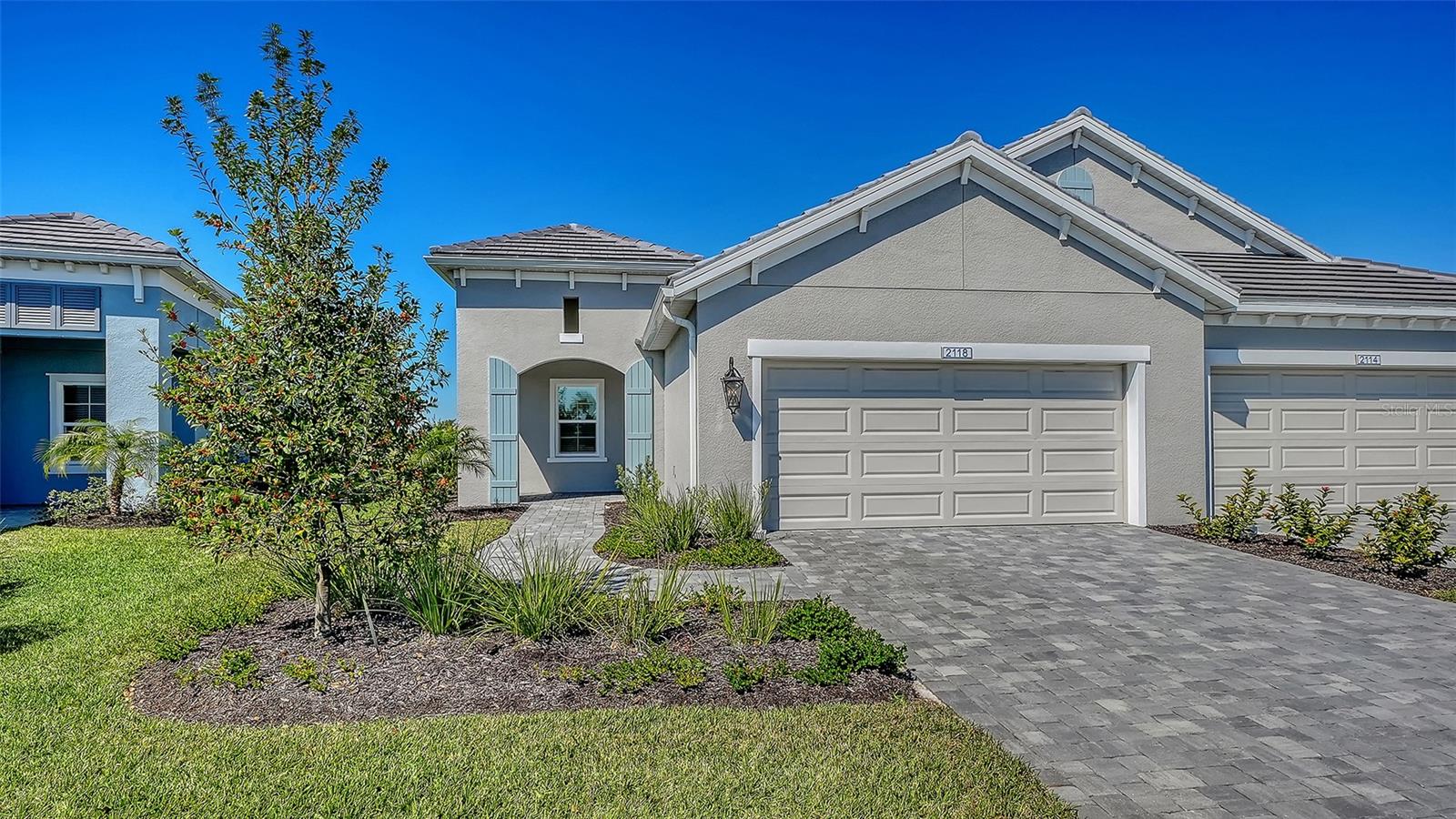 One or more photo(s) has been virtually staged. MOVE-IN READY NEW CONSTRUCTION VILLA IN PALM GROVE AT LAKEWOOD RANCH. This beautifully upgraded Neal Communities home offers a BRIGHT OPEN FLOORPLAN with 3 BEDROOMS, 2 BATHS, AND A DEDICATED INTERIOR LAUNDRY ROOM, all thoughtfully designed for easy Florida living. The kitchen features QUARTZ COUNTERTOPS, STAINLESS STEEL GAS APPLIANCES, A LARGE CENTER ISLAND, AND POCKET SLIDING GLASS DOORS that open to the SCREENED AND EXTENDED LANAI, perfect for indoor-outdoor entertaining. The primary suite includes a WALK-IN CLOSET AND SPA-STYLE BATH, while impact-resistant LOW-E DOUBLE-PANE WINDOWS, a GAS WATER HEATER, and SMART HOME FEATURES add comfort and efficiency. Located in GATED PALM GROVE AT LAKEWOOD RANCH, residents enjoy a RESORT-STYLE POOL, CLUBHOUSE, FITNESS CENTER, PICKLEBALL COURTS, PARKS, PLAYGROUND, AND SCENIC WALKING TRAILS, all with MAINTENANCE-ASSISTED LIVING and easy access to Lakewood Ranch amenities, shopping, dining, and top-rated schools.