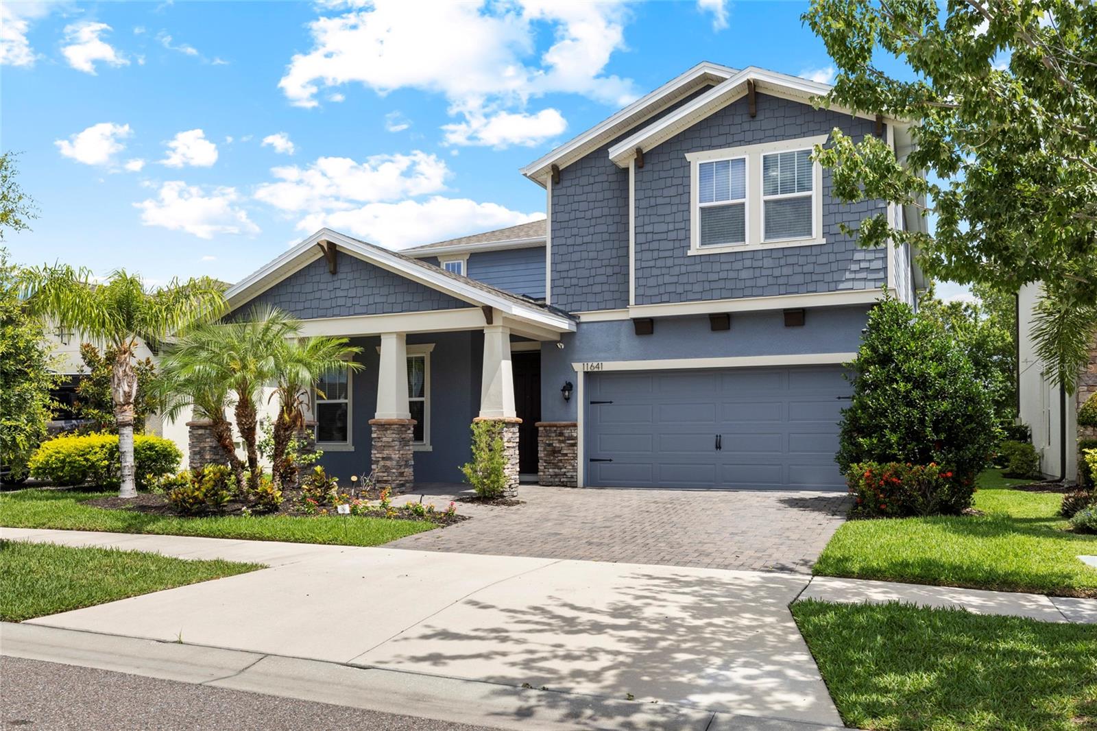 "Some photos have been virtually staged to illustrate the potential of the space; furniture is digitally added." Welcome to this better-than-new, impeccably maintained home in the gated community of Reserve at Citrus Park, ideally situated in the highly desirable Westchase area. Built by Beazer Homes, this spacious Windjammer floor plan offers 4 bedrooms, 3 bathrooms, a large loft, and over 3,000 square feet of thoughtfully designed living space. A welcoming front porch and charming Craftsman-style exterior featuring shaker shingle detailing and natural stone accents create exceptional curb appeal and a warm first impression.Step inside to find wood-look tile flooring throughout the main living areas and a formal dining room conveniently tucked off the kitchen, creating the perfect setting for holiday gatherings and special occasions. At the heart of the home is a spacious open-concept kitchen overlooking the family room and dinette area, making entertaining effortless. Designed with both style and functionality in mind, the kitchen showcases rich 42 inch wood cabinetry, light quartz countertops, stainless steel appliances, built-in double ovens, a stainless farmhouse sink, tile backsplash, and a large walk-in pantry. The first floor also features a private guest bedroom and full bathroom, making it an excellent option for visitors, a home office, or multi-generational living. The washer and dryer are also included for added convenience. A desirable first-floor guest bedroom and full bathroom offer flexibility for visitors, multigenerational living, or a private home office. Upstairs, the expansive loft provides an ideal secondary living area, media room, game room, home office, or playroom. The spacious primary suite serves as a relaxing retreat with a large walk-in closet and ensuite bath, while two additional bedrooms and a full bathroom complete the second floor. Step outside to the covered rear patio overlooking a spacious backyard with endless possibilities. Whether you envision a sparkling pool, outdoor kitchen, fire pit, or the outdoor oasis of your dreams, there is plenty of room to bring your vision to life. The generous outdoor space offers flexibility and functionality while creating the perfect setting to enjoy Florida's year-round lifestyle. Residents of Reserve at Citrus Park enjoy the security of a gated entrance and a community dog park, all while being conveniently located near Westchase, Tampa International Airport, top-rated schools, shopping, dining, golf courses, and major commuter routes. Combining modern finishes, flexible living spaces, exceptional outdoor potential, and an unbeatable location, this beautifully maintained home offers the perfect blend of comfort, style, and convenience.