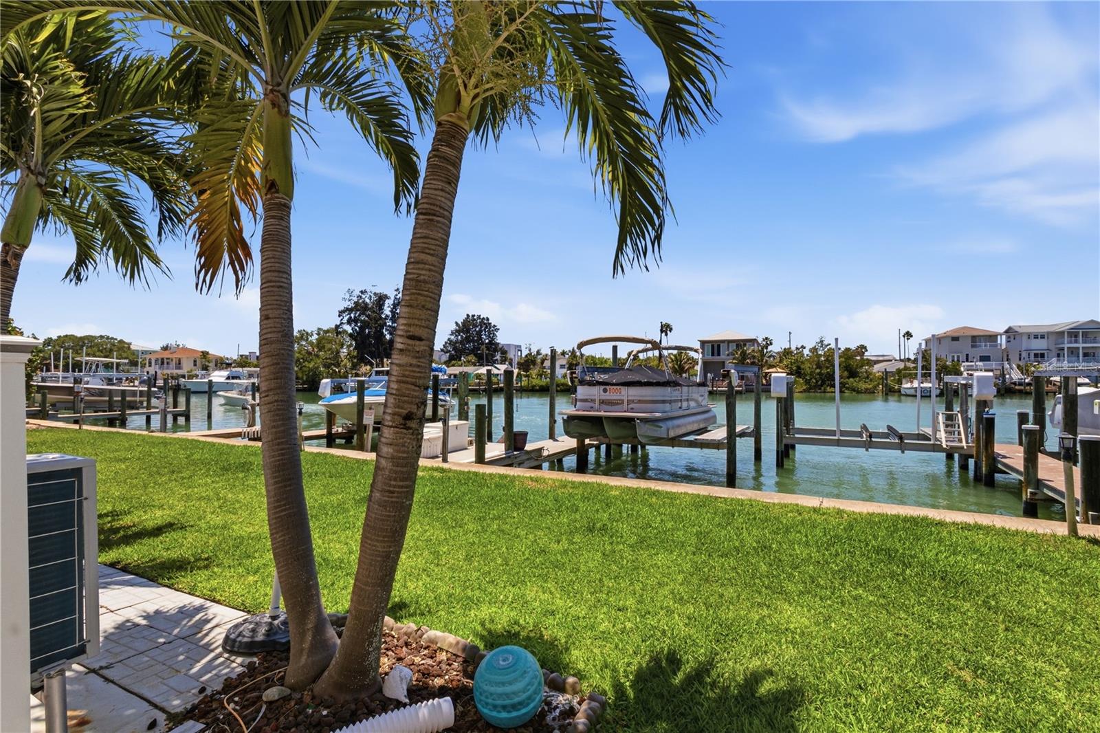 One or more photo(s) has been virtually staged. Welcome to the highly sought after Treasure Island Capri Lagoons Community.  This 2BR|2.5BA townhome has been updated in recent years with a chef's kitchen with high end stainless steel appliances including a farmhouse style stainless steel sink, granite counters, lacquer cabinets with an oversized Island with abundant storage.   The living room offers a wood burning fireplace for those cooler winter evenings. This townhome offers a one-car garage with extra storage. For all you boating enthusiasts the unit INCLUDES A BOAT DOCK WITH A 20,000LB LIFT offering easy access to the Gulf and the Intercoastal Waterway. Schedule your private showing today!