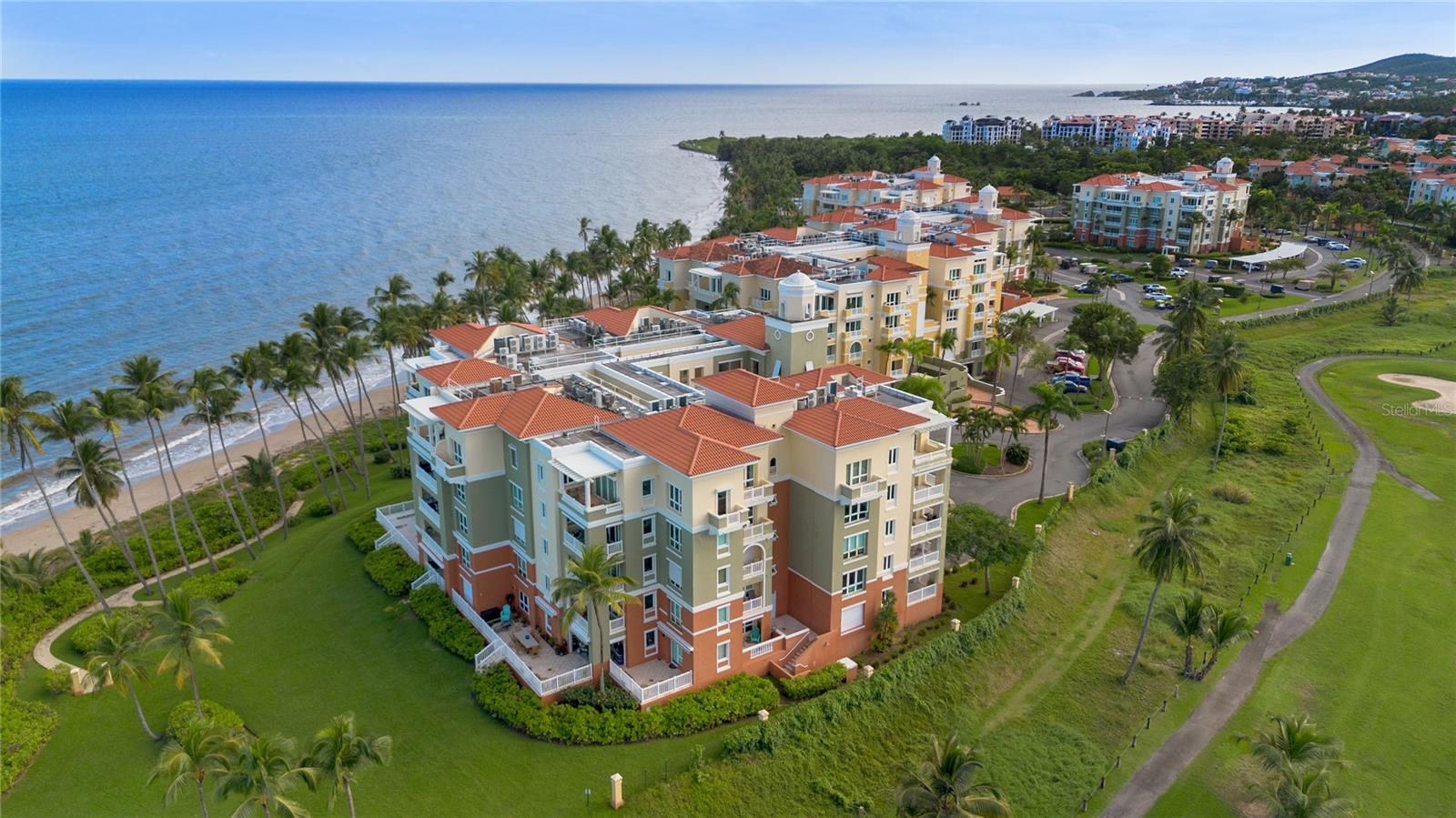 Welcome to an exceptional oceanfront penthouse at the Marbella Club, located within the Palmas del Mar Resort. Offering approximately 2,600 square feet, this residence delivers a refined coastal lifestyle defined by space, light, and breathtaking natural scenery.

High ceilings, elegant crown moldings, and an open-concept layout create a seamless flow throughout the home, while expansive windows frame uninterrupted views of the Atlantic Ocean, golden beaches, and the lush mountains of El Yunque. Every space is designed to highlight the surrounding landscape and bring the outdoors in.

The main living areas include a spacious living room, formal dining area, and a modern kitchen featuring stainless steel appliances, quality wood cabinetry, and granite countertops. A generous private terrace extends the living space outdoors, ideal for entertaining, dining al fresco, or simply enjoying the ocean breeze and panoramic views.

The primary suite serves as a private retreat with a large bedroom, sitting area, private balcony, and a spa-inspired en-suite bathroom. An additional independent suite with its own bathroom offers flexibility for guests or multigenerational living, complemented by well-proportioned additional bedrooms.

Residents of the Marbella Club enjoy direct beach access, two oceanfront swimming pools, a jacuzzi, and beautifully landscaped tropical grounds. As part of Palmas del Mar, owners also have access to championship golf courses, tennis and pickleball facilities, a marina, equestrian center, dining, shopping, and 24-hour security. The community is also home to The Palmas Academy, conveniently reached by golf cart, a daily experience many families cherish as ch¡ldren enjoy being taken to school through the resort’s scenic paths.

An outstanding opportunity for a primary residence, vacation home, or income-producing investment in one of Puerto Rico’s most desirable coastal communities.