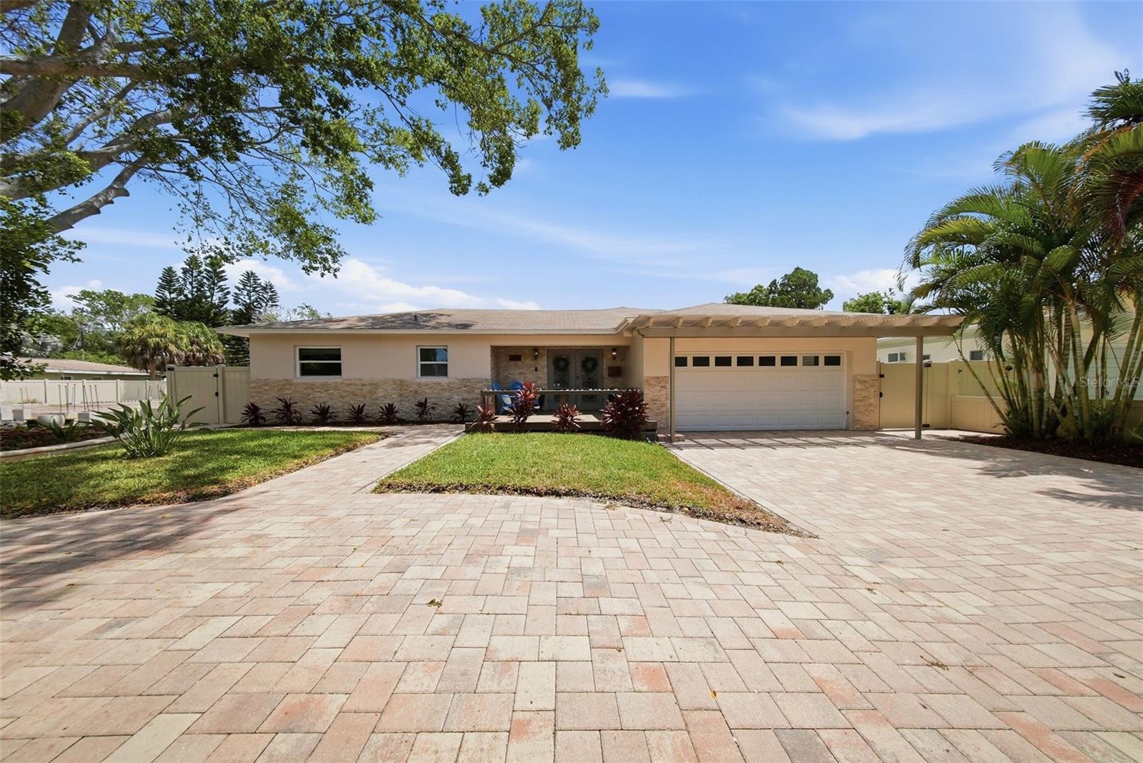 An exceptional opportunity awaits in the highly sought-after community of South Pasadena. Situated on an oversized 0.29-acre lot, this spacious 3-bedroom, 4-bath residence offers more than 2,200 square feet of flexible living space and endless possibilities for homeowners, investors, or those seeking a unique redevelopment opportunity.

The home features a desirable split-bedroom floor plan and has undergone significant improvements, including a new roof (2019), hurricane-impact windows and doors (2019), Icynene insulation (2019), and extensive 2025 upgrades, including a new HVAC system, new water heater, completely renovated kitchen, and beautifully updated bathrooms.

At the heart of the property is an incredible outdoor living experience. The Olympic-size lap pool, built in 2019, is ideal for both fitness and relaxation and is complemented by a 100-square-foot spa and an expansive 560-square-foot covered patio featuring a cozy gas fireplace. Whether entertaining guests or enjoying a quiet evening outdoors, this backyard oasis delivers the ultimate Florida lifestyle.
Mature Areca and Foxtail palms provide privacy and tropical charm, while the spacious yard offers plenty of room for pets, gardening, play, or future enhancements. Additional features include a two-car garage, oversized utility room with space for a full-size washer and dryer, and two large exterior storage rooms totaling more than 330 square feet.

A substantial 900-square-foot addition completed in 2019 and a new patio added in 2024 further enhance the property's functionality and value. All major improvements have been properly permitted.

The property's RM-10 residential/multi-family zoning provides outstanding flexibility for future development, expansion, or investment potential. Convenient paved alley access adds additional functionality, while the prime location places you within walking distance of shopping and everyday conveniences.

Just minutes from the Gulf beaches and vibrant downtown St. Petersburg, this property combines location, lifestyle, and opportunity in one remarkable package. With continued growth and redevelopment occurring throughout the area, this is a rare chance to secure a large parcel in one of Pinellas County's most desirable communities.