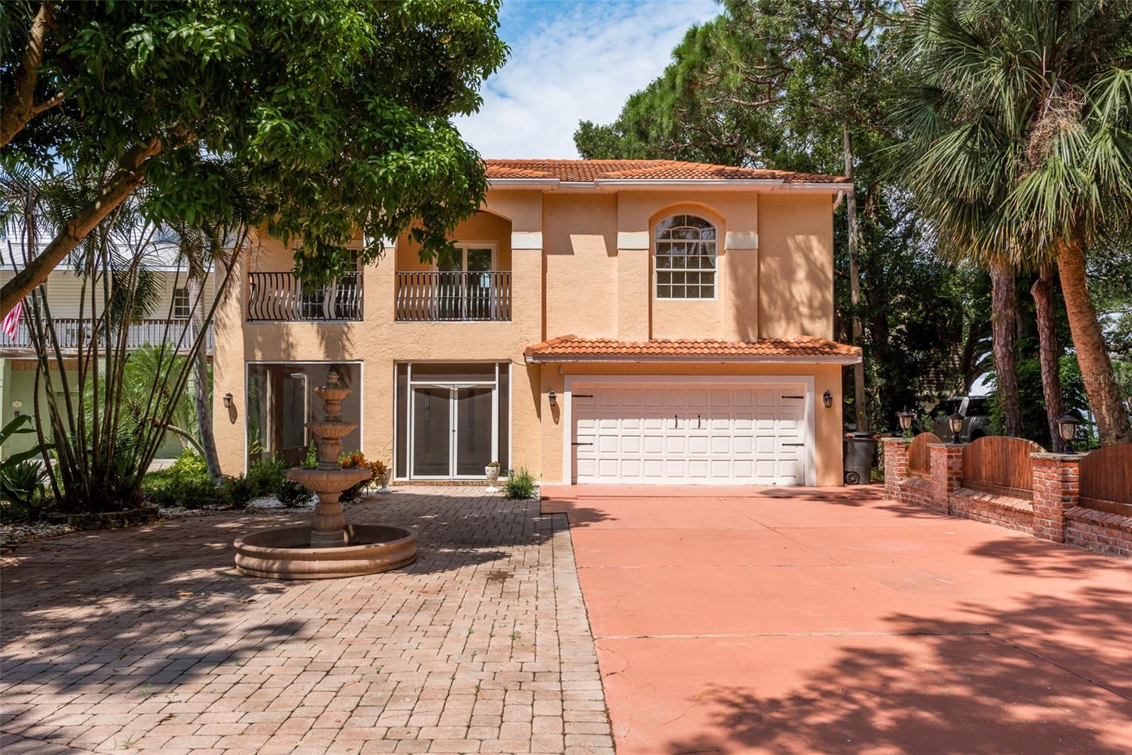 Virtually Staged. Step into your perfect waterfront escape in Palm Harbor - a beautifully updated 5-bedroom, 5.5-bathroom pool home that embodies the very best of coastal living.  Recent renovations and upgrades include new tile flooring throughout the first floor, fresh interior paint, a completely updated kitchen featuring new cabinetry, quartz countertops, and stainless steel appliances, along with crown molding, new ceiling fans, and new vanities on the first floor. Major system updates include all new A/C units (three total) installed in 2025, all-new electrical and electrical panel in 2025, and previously installed water heaters from 2022.  Spanning over 4,100 square feet across two inviting floors, this residence offers a seamless blend of comfort and breathtaking water views. The home did experienced damage from previous storms, which has since been fully remediated, with extensive upgrades completed - offering peace of mind and modern efficiency throughout. From the moment you arrive, the welcoming entryway draws you into a thoughtfully designed home where everyday living and entertaining come together effortlessly. The heart of the home is the open, updated kitchen. Off of the kitchen is the breakfast nook where sliding glass doors connect the dining area to the outdoor space, showcasing picturesque water views. The cozy back living area is ideal for unwinding, featuring coastal-style tile, a full wet bar with wine storage, and sliders that open to a second patio with direct access to the pool and serene waterfront backdrop. Upstairs, a comfortable lounge area offers a relaxing retreat, while a large bonus space - formerly a home gym - provides endless possibilities for a media room, additional living area, or flex space. This level also includes a washer and dryer hookup closet, eliminating the need to carry laundry between floors. The home offers two bedrooms on the lower level, one with a private en-suite bath and generous closet space, and three additional bedrooms upstairs, providing ample room for family, guests, or multi-generational living. Outside, the fenced backyard is a true tropical oasis with kayak storage, a tiki bar, and an outdoor kitchen with sink and dining island, all overlooking tranquil waters. Expansive patio areas provide plenty of space for entertaining, lounging, and enjoying evenings around a fire pit. For boating enthusiasts, the private dock extends into the Gulf, offering direct water access and endless adventure. Complete the experience by relaxing on the rooftop patio, where panoramic water views capture the essence of Florida’s coastal lifestyle. This Palm Harbor waterfront home combines space, flexibility, and extensive updates with incredible outdoor living. Don’t miss the opportunity to own this exceptional coastal property - schedule your private showing today and start living the waterfront lifestyle you’ve been dreaming of.