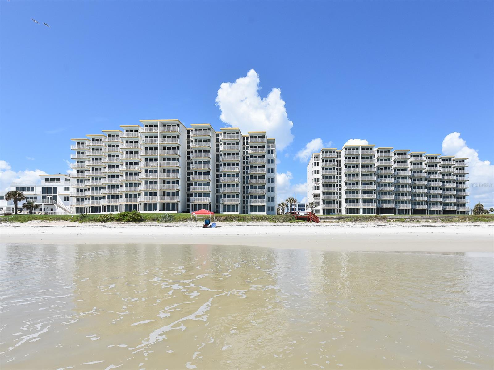 Rarely available DIRECT OCEAN FRONT 3 bed/2.5 bath condo with BREATHTAKING unobstructed views of the OCEAN and NORTHERN and SOUTHERN COASTLINES! You will feel immediately at home in this roomy, upgraded beach condo with tile floors and open kitchen. Relax on the balcony with your morning coffee watching the sunrise over the ocean and be prepared to be amazed as you watch rocket launches from your balcony or from the beach! LOW HOA fees, pet friendly, and strong rental history in this complex. Common amenities include an oceanfront geothermal heated swimming pool, clubhouse, tennis courts and shuffleboard/horseshoes/grill area; all set on beautifully manicured grounds in a safe gated community. Close to historic Flagler Avenue and Canal Street where you can enjoy shopping, restaurants, festivals and night life. Under 1 hour 15 minutes from 3 airports and all of the Orlando attractions! Do not pass on one of New Smyrna Beach’s best kept secrets! ;Water: City