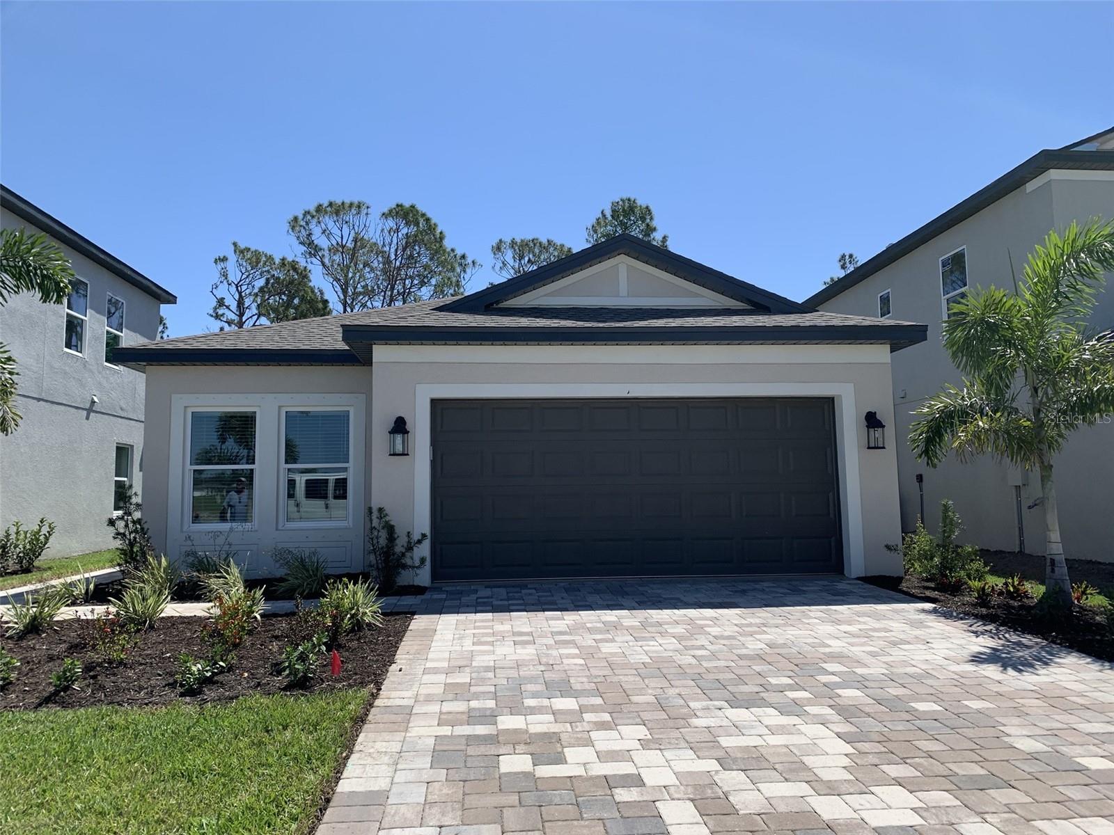 Newer, Big and Beautiful West Port Home. A newer, beautiful 1-story home in West Port. The floor plan of this home includes 3 bedrooms, 2 bathrooms, an open-concept kitchen and great room, a covered lanai, and a 2-car garage. Upon entering the foyer, the flex room will greet you on the side, perfect for an in-home office, playroom, or media room. Around the corner, discover the entrance to 2 full bedrooms and a full bath, the ideal area for guests or family. Walking into the main area, the home features a spacious kitchen, a large island with a sink for food preparation, and extra counter space. The kitchen looks out onto the dining room, making it a perfect place for family gatherings and entertainment. You'll find the owner's suite tucked in a corner of the great room, offering privacy and space while keeping you connected to the heart of your home. Enjoy a large walk-in closet with an owner’s bath with 2 sinks and a private water closet. This home is close to the Charlotte County Recreation Center, shopping, and restaurants! The patio overlooks a wooded area with a creek.