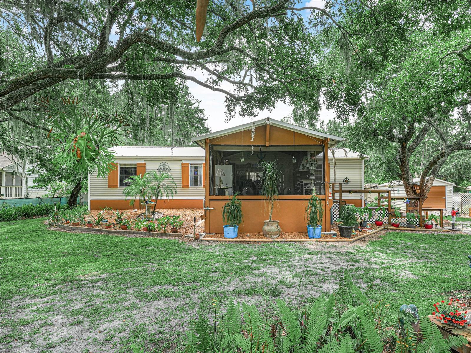 Looking for peace and quiet with no HOA? This well-maintained 3-bedroom, 2-bath home sits on a half-acre shaded by beautiful mature oak trees and offers the perfect blend of comfort and privacy. The move-in ready split floor plan features an open living area, creating a spacious feel for everyday living and entertaining. Each bedroom includes a large walk-in closet, while the primary suite offers two walk-in closets and a separate shower. The metal roof provides durability and longevity, and there is plenty of storage with several sheds on the property. Enjoy your mornings and evenings on the oversized screened front porch while taking in the wildlife and peaceful surroundings. Located within next to of Lake Marian Marina, overlooking 5,800 acres of water, this quiet community is a fisherman's paradise and offers access to a public boat ramp. There is also parking for a boat and a charging station in the yard. If you're looking for a place to enjoy the outdoors and a slower pace of life, this property is worth a look. Schedule your showing today.