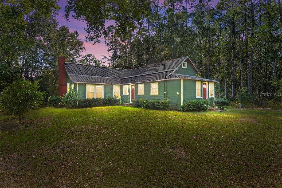 Assumable Mortgage available $165k at 3 5/8% interest rate. Step Back in Time Where History Meets Lakefront Serenity. Welcome to the Old McIntosh House — a timeless historic gem believed to have been built in 1908, officially recorded in 1950. Lovingly restored and thoughtfully updated, this remarkable home perfectly blends Old Florida charm with modern comfort. Nearly 8 acres along spring-fed Lake Jeffords, one of North Central Florida's most peaceful and picturesque lakes. Built by Edgar Johnson, this one-of-a-kind residence first served as the Hawthorne town library before being carefully relocated to its tranquil lakeside setting in 1990. Today, it stands as a living piece of history - surrounded by majestic oaks, natural landscaping, and about 200 feet of private lake frontage. Inside, this home's history shines through every detail: 11-foot ceilings, original cypress wood floors, handcrafted beadboard walls and ceilings, and authentic millwork preserved with care. Two wood-burning fireplaces, one in the great room and one in the primary suite, create inviting spaces to gather and unwind. The sunroom and the bonus room offer versatility and plenty of natural light perfect for reading, hobbies, or a quiet home office. The kitchen blends character and convenience with refinished original cabinetry, a composite farm sink, dishwasher, new refrigerator, and glass-top stove. Every upgrade honors the home's heritage while ensuring long-term comfort, including a brand-new metal roof (April 2025) and numerous mechanical updates for worry-free ownership. A scenic driveway easement leads you to your own private, gated entrance, where the property opens up into a serene, park-like retreat. Here, manicured beauty meets natural wilderness of the property includes lush wetlands near the lake's edge, creating a rich habitat for deer, turkeys, and countless bird species that enhance the property's peaceful, natural charm. Enjoy quiet mornings on the back deck, peaceful afternoons watching wildlife, and golden sunsets reflecting on the water. Whether you're seeking a full-time residence, a winter escape, or a multi-generational family compound, this property offers privacy, space, and soul in one extraordinary package. Located just 35 minutes from the World Equestrian Center in Ocala, and  minutes to Gainesville, Melrose, and Hawthorne, this lakeside retreat combines historic beauty, modern comfort, and accessibility to everything North Central Florida has to offer. With no HOA, an assumable mortgage option with a very low interest rate, this one-of-a-kind property invites you to continue its story where history, nature, and comfort meet on the peaceful shores of Lake Jeffords. 
Improvements Include:
 New Metal Roof - April 2025, New Well & Pump (2023) - with warranty, Water Purification System (2023), Electric Car Charging Station (2024), Septic Tank Pumped (2023), New HVAC (2023) with 10-year warranty, dishwasher (2024), Farm sink (2022), Glass-top stove (2021).