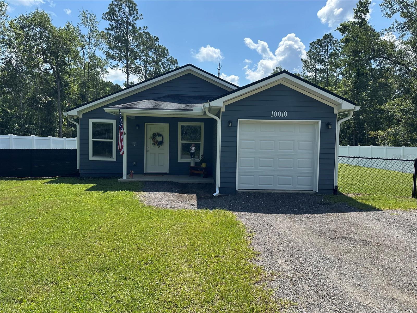 Virtually Staged. Peaceful and private country living right here in Hastings, Fl - come and see this 3-bed, 2-bath home on just over an acre in the Flagler Estates area.   Built in 2023 , this nearly new home has been maintained and improved by current owner.  All new sod , a blend of vinyl privacy fence and chainlink fence in a portion of the expansive backyard,  a new  refrigerator and range have been added as well.  This light and airy home has an indoor laundry room on the way to the garage , 3 nice sized bedrooms and luxury vinyl plank flooring throughout.  The spacious kitchen has a breakfast bar, soft close shaker cabinets with beautiful quartz counter tops giving a modern feel. All bedrooms have generous closets with the primary bedroom boasting a 14' wide closet! There is a pump house for well water with brand new pump and water softener. Plenty of parking for all of your toys and room to add a workshop or secondary garage. Call to see this turn key home today!