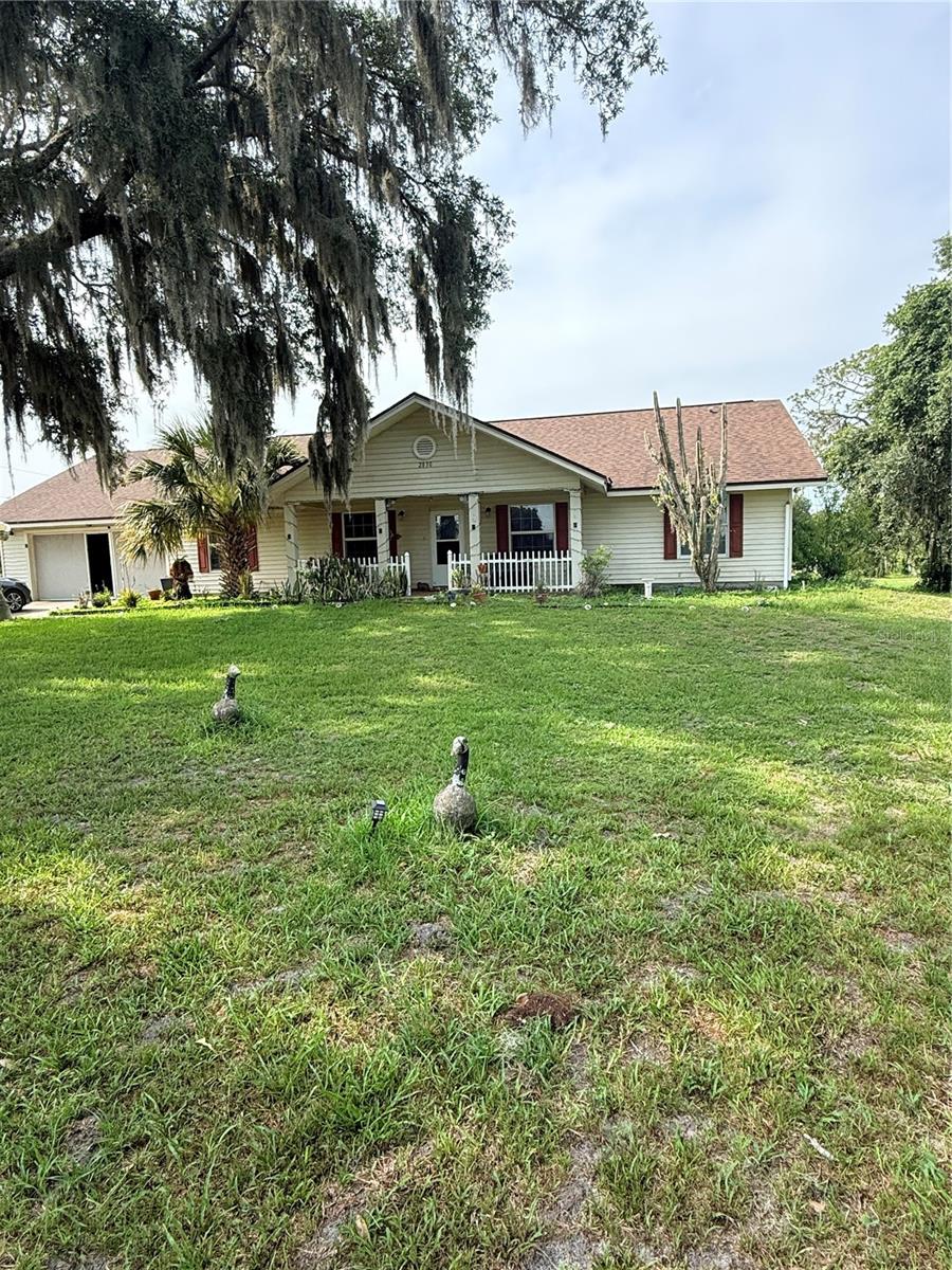 4-bedroom, 2.5-bath home situated on 5.5  acres +/- of cleared land with mature oak trees and fruit trees. Bring your livestock, outdoor toys, trailers, and equipment—there is plenty of room to enjoy country-style living with the convenience of being close to everything. This 1,980-square-foot property is partially fenced and offers space, privacy, and flexibility with no HOA and no CDD. Plenty of room to build your dream homestead. Ideally located near the Turnpike entrance, making commuting and access to shopping, dining, schools, and local amenities easy. A rare opportunity to own acreage in a convenient location!