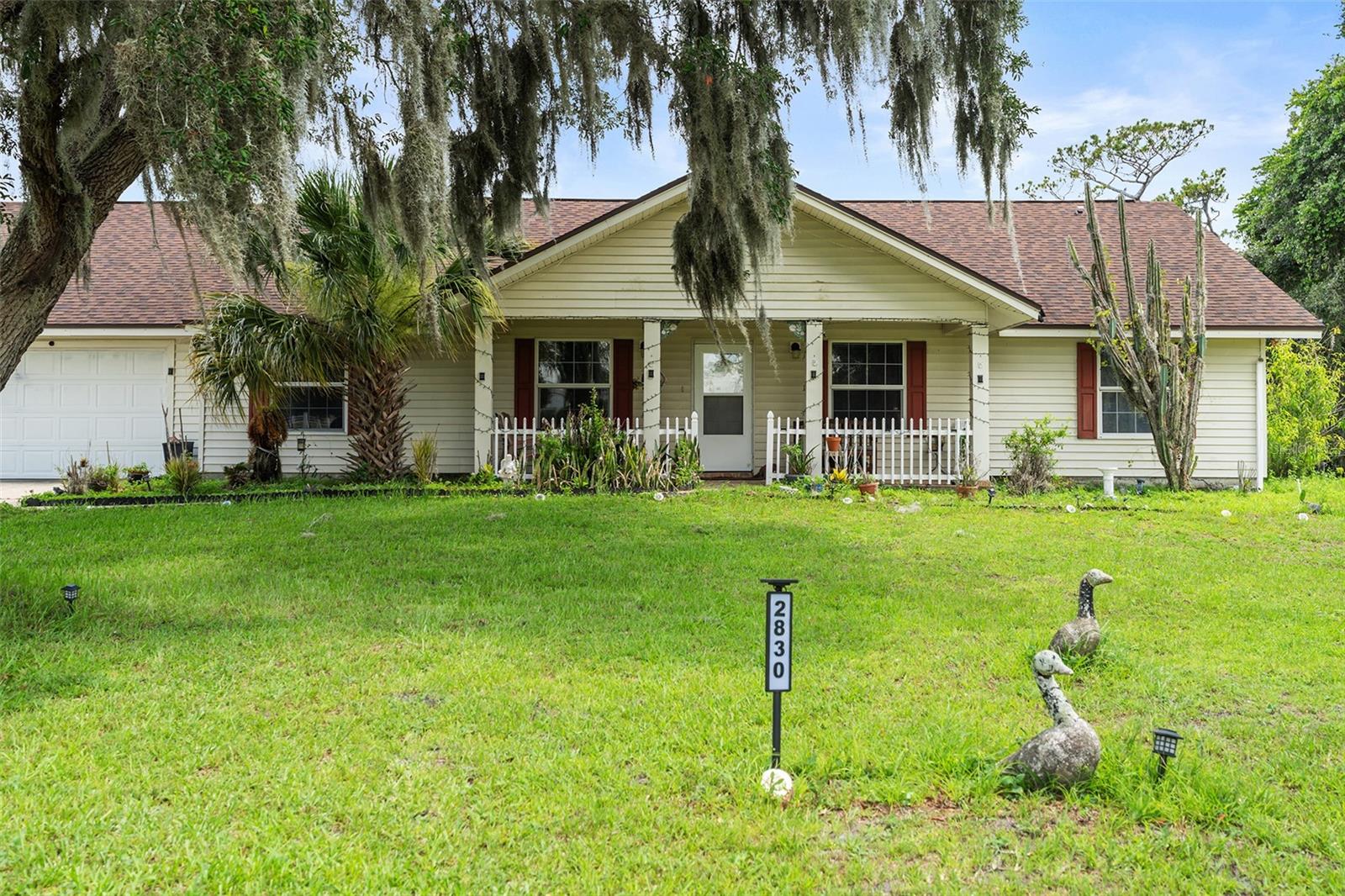 4-bedroom, 2.5-bath home situated on 5.5  acres +/- of cleared land with mature oak trees and fruit trees. Bring your livestock, outdoor toys, trailers, and equipment—there is plenty of room to enjoy country-style living with the convenience of being close to everything. This 1,980-square-foot property is partially fenced and offers space, privacy, and flexibility with no HOA and no CDD. Plenty of room to build your dream homestead. Ideally located near the Turnpike entrance, making commuting and access to shopping, dining, schools, and local amenities easy. A rare opportunity to own acreage in a convenient location!