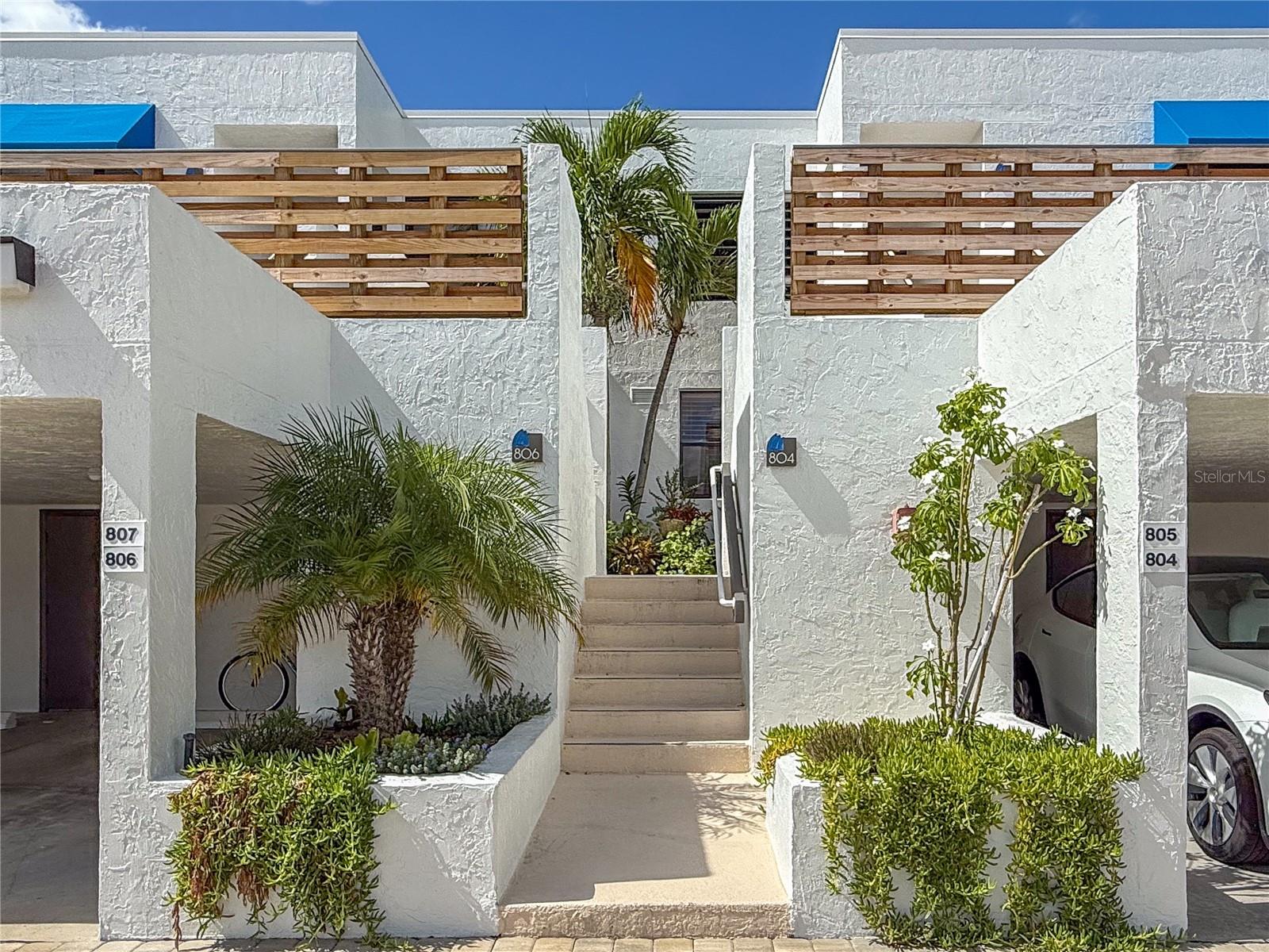Welcome to this beautifully appointed ground floor residence that combines modern elegance with functional design. Newly remodeled in 2025, this residence features high-end finishes and modern amenities, making it an ideal retreat for those seeking luxury in a serene
environment.
Upon entering, you are greeted by a bright and spacious interior filled with natural light, thanks to strategically placed additional windows  featured in corner/end units of this community. The subtle elegance of the interior is complemented by sleek flooring that enhances the flow from room to room. The kitchen is a true highlight, featuring quality cabinetry, elegant quartz counters, and modern stainless-steel appliances, which allow a harmonious flow, delivering both functionality and sophistication.

The open-concept layout continues through the dining and living areas, combining a blend of textures and stylish finishes to cohesively create an environment of relaxed elegance. An abundance of natural light floods this space through large retractable sliding glass doors, which provide the option of extending the outdoors in. A private outdoor patio showcases a beautiful backdrop of lush tropical landscaping, adding to the property’s overall appeal.

The bedrooms within the property are thoughtfully designed, each offering generous space and natural light. The primary suite offers a restful retreat, complete with an ensuite bathroom featuring modern fixtures and thoughtful design, ensuring comfort and privacy.

This property will continue to amaze, as beauty extends beyond its walls into an amenity-rich community of 27 acres of picturesque tropical landscaping. This gulf-to-bay community offers an active island lifestyle with 4 Har-Tru tennis courts, a Jr. Olympic sized (heated) pool, private fishing pier, kayak facilities, Bocce court, and amazing nature trails. A distinct advantage and unique selling point of this property is its proximity to a private, deeded beach. This property offers future owners not just exclusive beach access, but a revitalizing retreat amidst the hustle and bustle of life—truly a valuable benefit that amplifies the charm of this residence. Close to local amenities yet precisely
positioned to offer privacy and quietude, this property represents an excellent opportunity for discerning buyers. Experience the best of coastal living in this beautiful home, where modern comfort meets natural beauty.  Welcome home!