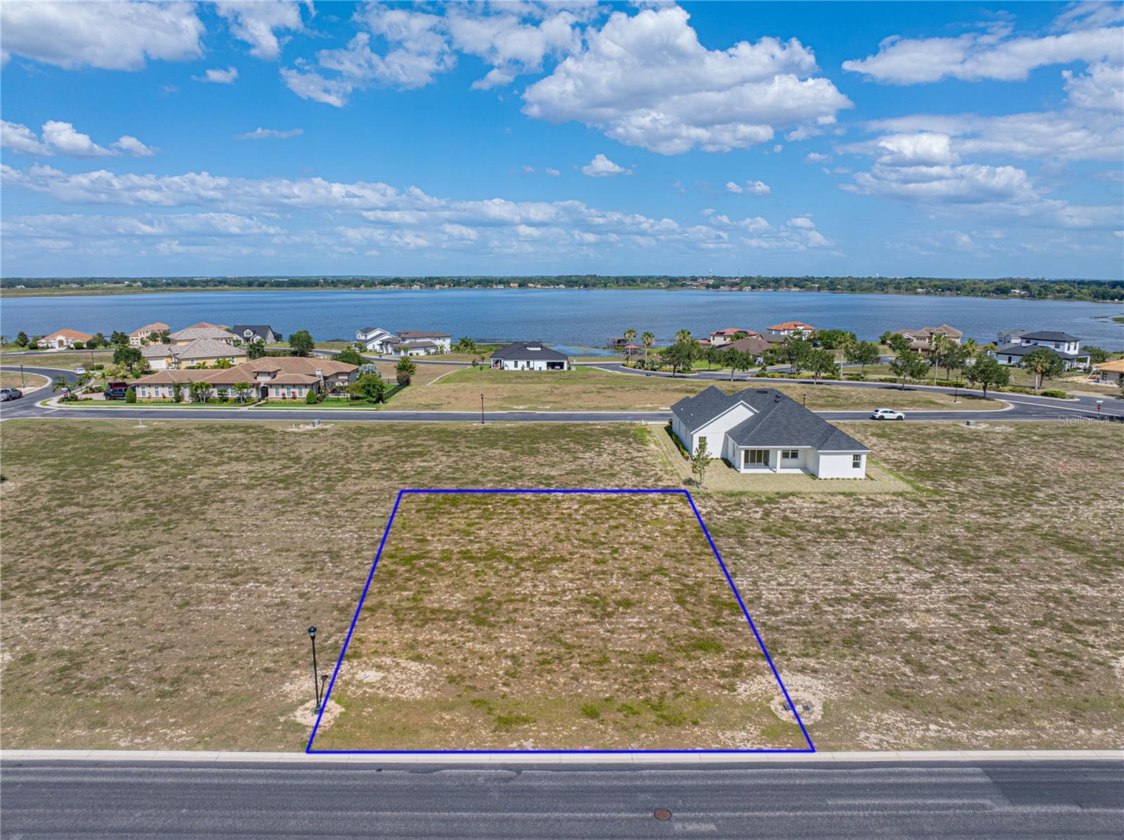 WATER RIDGE--A GATED LAKERONT COMMUNITY.  This lot in the upscale neighborhood is located close to the Lake Alfred side gate.  The community has access to three lakes--Lake Alfred, Lake Medora and Lake Van.  There are lots of amenities--pools, fishing docks, tennis and pickleball courts, boat ramps, gym, RV and boat storage and a gorgeous clubhouse.  The community is positioned between Orlando and Tampa and close to all that Central Florida has to offer.  Come build your dream home.