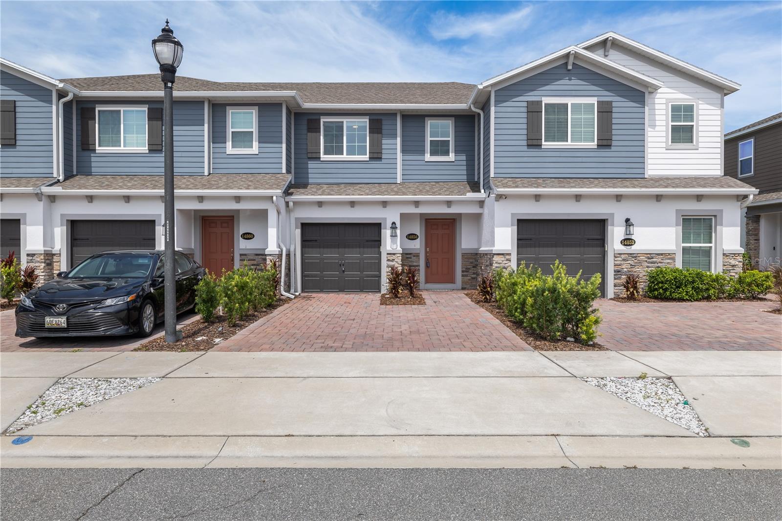 Rent to Own Available! $1,000 Closing Cost Incentive with Preferred Lender. Your ultimate LAKE NONA lifestyle awaits in this freshly DEEP-CLEANED 3-bedroom, 2.5-bathroom townhome less than 5 minutes from the brand-new LAKE NONA WEST! You are just steps away from the new Target drive-thru, Publix, Starbucks, and Chipotle, with the ORLANDO INTERNATIONAL AIRPORT (MCO) under 10 minutes away—making this perfect for your FAMILY or a long-term INVESTMENT. Inside, the bright, OPEN-CONCEPT space features light flooring, comfortable carpeted bedrooms, and a stunning kitchen with white cabinets, subway tile, and BRAND-NEW PENDANT LIGHTS over the large quartz island. The owner also added a newer thermostat and fresh A/C gas to keep you perfectly cool all summer. Outside, enjoy beautiful coastal blue siding and a brick paver driveway. What truly sets this home apart is its location in a RARE 4-UNIT BUILDING, rather than the usual crowded 6-unit rows. Built with top-tier BLOCK-ON-BLOCK CONSTRUCTION, you get incredible NOISE REDUCTION between neighbors, lower energy bills, and major peace of mind during HURRICANES. Do not pass this up! Our preferred lender is offering $1,000 TOWARD CLOSING COSTS, and if a traditional bank loan does not work for you right now, this home is fully approved for an exclusive RENT-TO-OWN PROGRAM so you can move in immediately while you get ready to buy!