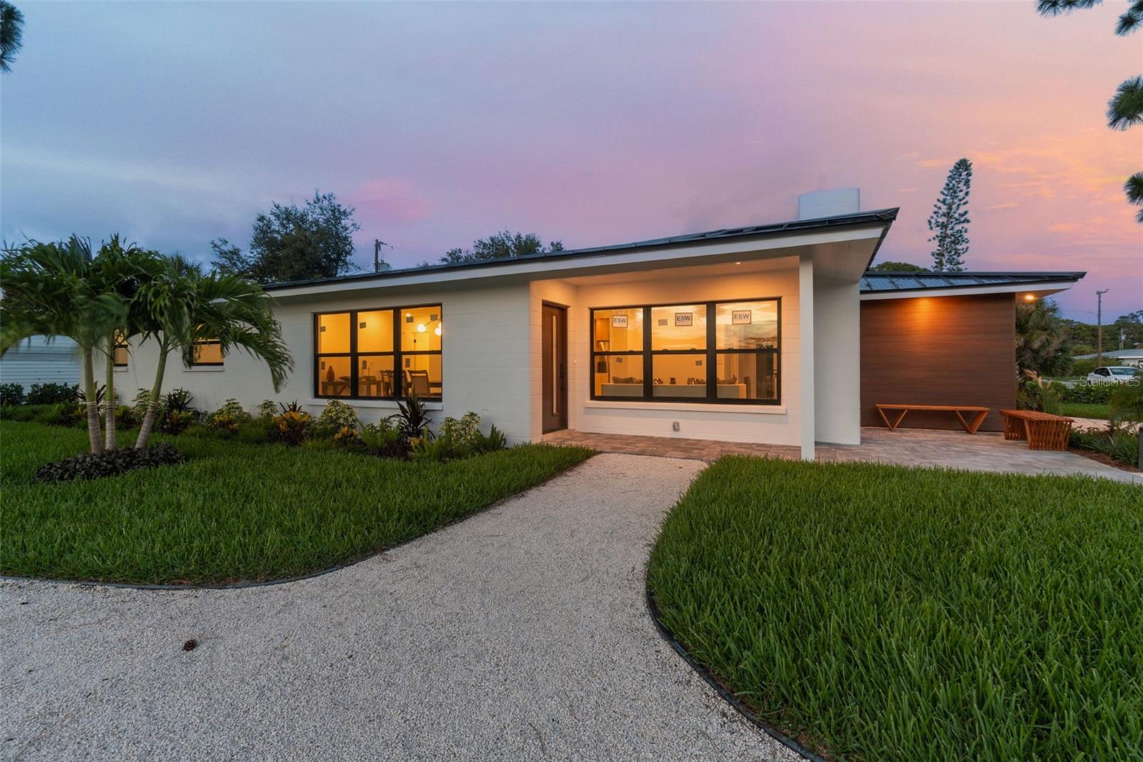 Indulge in the coastal allure of this exceptional 3-bedroom, 2-bathroom, home, ideally located on Venice Island just moments away from the sandy shores of Venice Beach. Immerse yourself in the laid-back elegance of this meticulously upgraded residence, where every detail reflects a commitment to quality and style. Approaching the property, you'll be captivated by the landscaping that sets the stage for a warm welcome. Step inside to experience the offering both an expansive and well-connected layout that is perfect for entertaining or just relaxing. The kitchen boasts high-end designer white oak cabinets, quarts counter tops, water fall island with seating, under-cabinet lighting, a quarts sink, full height glass tile backsplash, LG refrigerator with dual ice maker that makes round craft ice, Built in trash cans, magic blind corner cabinet, light rail, riser molding & high end cabinet hardware that is simple but elegant.  Enjoy the convenience of new appliances throughout this well executed remodel all within an expanded layout that maximizes counter space & storage. Enjoy a good book or conversation with friends & family by the wood burning fire place in your living room. The large family room has a high-end white oak wet bar with floating shelves and a beverage & wine cooler that has a double door leading to 1000 sq. ft. paver patio creating a harmonious blend of indoor and outdoor living. Discover the master suite & Immerse yourself in luxury within the spa-like bathroom creating a serene and stylish atmosphere. The guest bedrooms, offer cozy retreats, while the updated guest bathroom provides modern amenities and style. The exterior area has undergone a stunning transformation with Florida friendly plants, Bismarck palm, Sylvester palm, Christmas palm, Foxtail palms trees, St. Augustine grass, new sprinkler system with a new pump for the well. The new Claudia hedge around the entire property will provide complete privacy with in a years time. Over the top outdoor lighting is new & lights up the property to enhance the beautiful landscape & key features of the building so you can enjoy the outdoor space at all hours. New hot tub and expanded lanai to add to the outdoor experience.  This home is versatile & beyond luxury & prioritizes practicality. Updates include a aluminum new roof , all new electric wires & electric panel with led lights. Electric put under ground, Low E hurricane-rated doors & ESW Low E hurricane-rated windows. In a X zone, meaning no flood insurance is required. Sensonic ceiling bathroom exhaust fans with bluetooth speakers. New AC, New Hot water heater. New modern door hardware with smart locks. New LG front loader washer & Dryer. This residence embodies a perfect blend of style and safety. Located just blocks from Sharky's pier, 1 mile to service club park with beach access, and historic downtown Venice, this property positions you at the nexus of coastal living. Enjoy proximity to golf courses, the shimmering Gulf of Mexico, and the lively atmosphere of Venice's historic district. This home is a distinctive gem, offering a unique living experience in a coveted coastal destination.