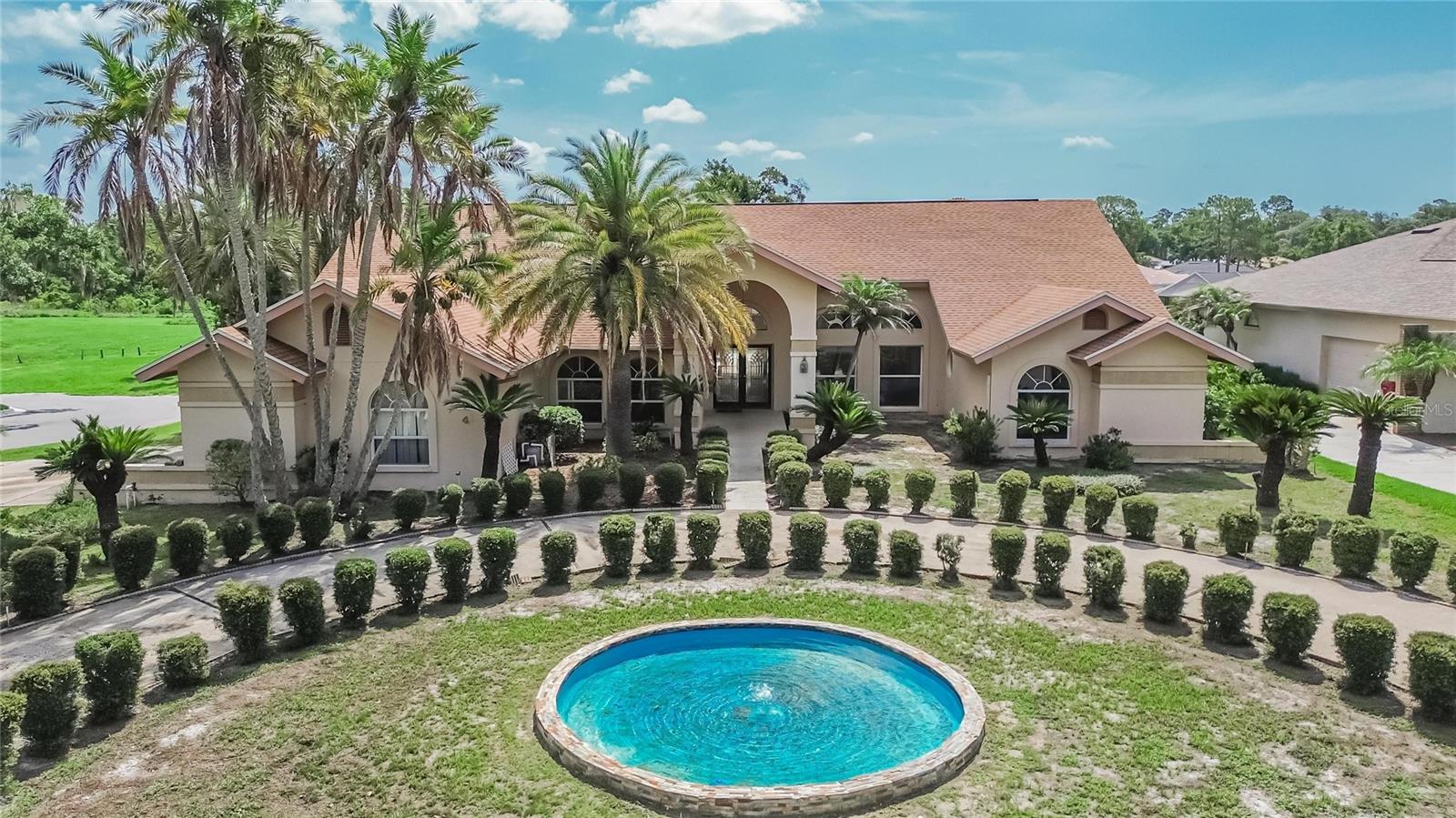 Welcome to an exceptional opportunity in the highly sought-after Forest Club in Walden Lake, where spacious custom homes, mature landscaping, and peaceful surroundings create one of Plant City’s most desirable addresses. Situated on a beautifully landscaped half-acre lot, this impressive single-story residence offers more than 3,800 square feet of thoughtfully designed living space, combining timeless architecture, exceptional functionality, and endless possibilities for its next owner. Whether you’re searching for room to grow, space to entertain, or the opportunity to create your dream home, this property delivers an outstanding foundation in an established community.

Designed with comfort and flexibility in mind, the home features five bedrooms, including a versatile fifth bedroom that can easily serve as a home office, fitness room, media room, or private guest suite. The expansive primary suite is truly a retreat, complete with two generous walk-in closets, a cozy fireplace, and the rare luxury of dual full bathrooms. Soaring ceilings, oversized living spaces, and abundant natural light create an inviting atmosphere throughout the home, while multiple gathering areas provide the perfect balance of openness and privacy for everyday living or entertaining.

At the heart of the home, the spacious kitchen offers abundant cabinetry, extensive counter space, and an excellent layout ready to be transformed into the gourmet kitchen you’ve always envisioned. Adjacent to the kitchen, the inviting family room features a beautiful fireplace, custom built-in shelving, and a wet bar, making it the perfect setting for holiday gatherings, game days, or quiet evenings at home.

Outdoor living is equally impressive. The screened lanai overlooks a large pool and spa, creating your own private backyard retreat. An additional outdoor entertaining area offers ample space for dining, relaxing, or designing the outdoor kitchen of your dreams. Completing the home is a desirable side-entry three-car garage, providing generous storage and outstanding curb appeal.

Major updates provide peace of mind, including a new roof installed in 2022, one HVAC system replaced in 2025, and the second HVAC system receiving a new motor in 2025. While the home’s classic style presents an exciting opportunity for cosmetic updates, it is priced to allow the next owner to personalize finishes without paying a premium for renovations that may not reflect their own taste.

Life in Walden Lake offers far more than just a beautiful home. Residents enjoy miles of scenic walking and biking trails, picturesque lakes, parks, playgrounds, dog parks, and a community sports complex, all just minutes from shopping, dining, medical facilities, and convenient access to Tampa, Lakeland, and Orlando. Opportunities to own a custom home of this size, on a half-acre lot, in one of Plant City’s premier neighborhoods are increasingly rare. This is your chance to create something truly special while enjoying the space, location, and lifestyle that make Walden Lake one of the area’s most enduring communities.