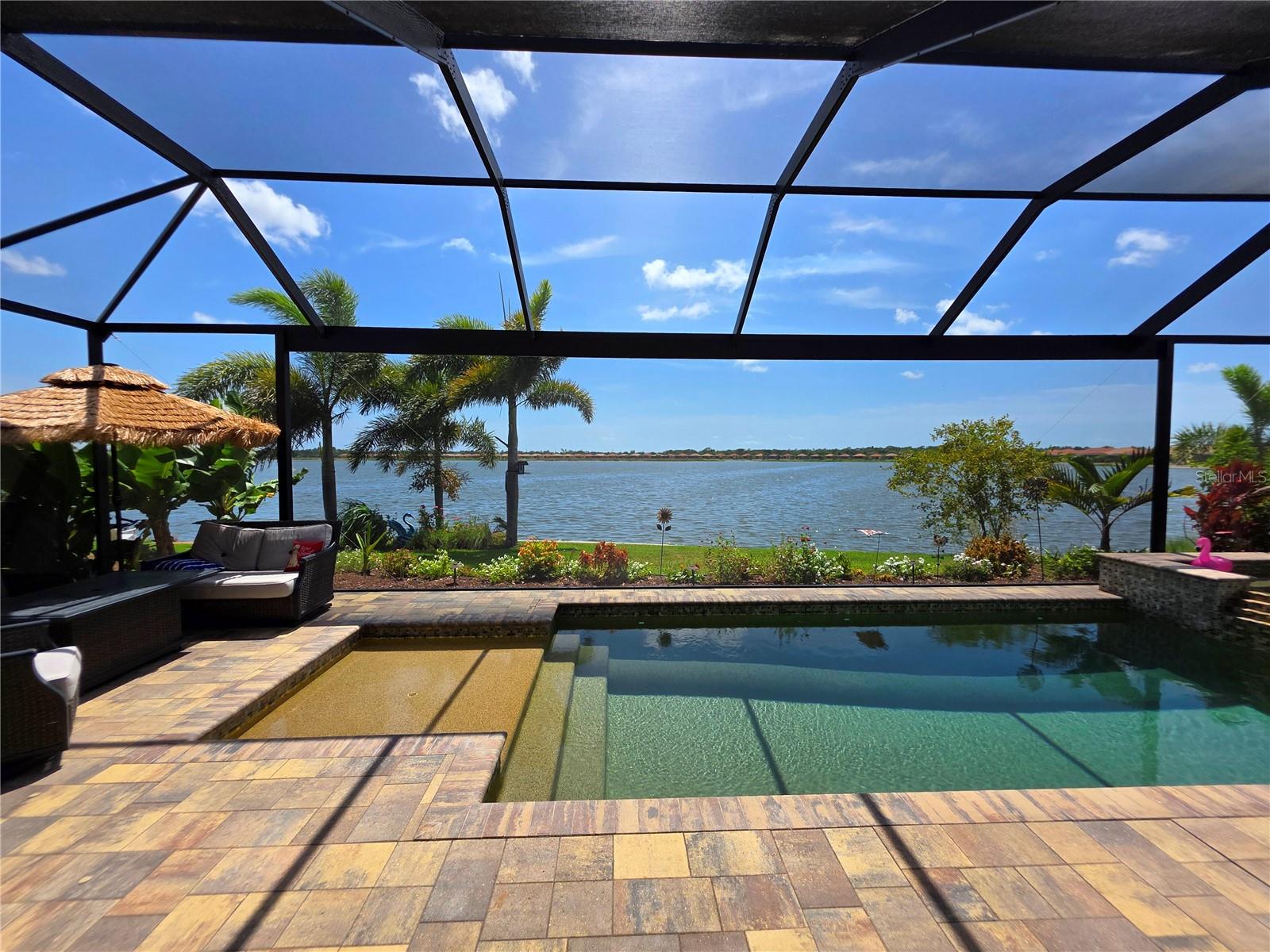 Experience exceptional waterfront living in this stunning lakefront residence, perfectly positioned on a premium homesite with breathtaking sunset views in the highly sought-after gated community of Toscana Isles. Featuring the popular Easton floor plan, this beautifully upgraded home offers 3 bedrooms, a private office, an expansive second-floor bonus room, 4 full bathrooms, 2 half bathrooms, including a convenient pool bath, and a tandem 3-car garage with epoxy flooring.

Designed for both everyday living and entertaining, the open-concept layout is filled with natural light and showcases elegant tray ceilings, custom shiplap accents, and porcelain tile flooring throughout the main living areas. The gourmet kitchen is equipped with granite countertops, upgraded cabinetry, a designer tile backsplash, stainless steel appliances, a walk-in pantry, farmhouse sink, and an oversized center island that serves as the heart of the home. The spacious primary suite offers dual walk-in closets and a luxurious ensuite bath featuring double vanities and a walk-in shower.

Step outside to your private resort-inspired waterfront oasis. The expansive screened lanai is designed for year-round Florida living and features a heated saltwater pool with a raised spa, sun shelf, and LED lighting. The covered outdoor living area includes a fully equipped outdoor kitchen with a built-in grill, refrigerator, ice maker, and sink, creating the perfect setting for entertaining family and friends while enjoying tranquil lake views and unforgettable sunsets.

Residents of Toscana Isles enjoy an impressive collection of resort-style amenities, including a gated entrance, elegant clubhouse, state-of-the-art fitness center, newly renovated heated infinity-edge pool, tennis and pickleball courts, and miles of interconnected lakes ideal for kayaking and fishing. Conveniently located just minutes from Nokomis Beach, Venice Island, Sarasota Memorial Hospital Venice Campus, premier shopping, dining, and I-75, this exceptional home offers the perfect blend of luxury, comfort, and the best of Florida's Gulf Coast lifestyle.