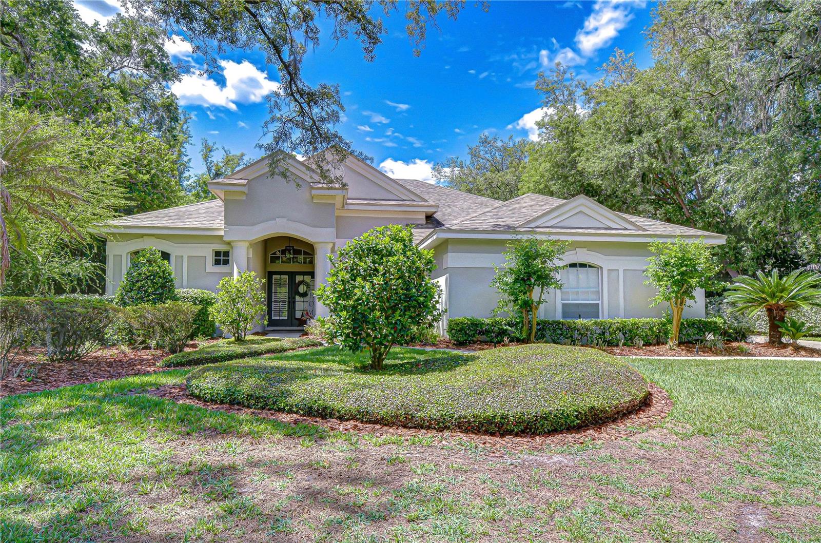 ** ASSUMABLE VA LOAN @2.25%, FOR VA QUALIFIED BUYER** WELCOME TO YOUR PRIVATE PARADISE IN GATED FISH HAWK TRAILS. Tucked beneath a canopy of mature trees on a half-acre homesite, this exceptional executive residence is designed to impress at every turn—offering a rare combination of a triple-split bedroom floor plan, dedicated office, spacious bonus room, and an outdoor retreat straight from the pages of a luxury magazine. Step outside and prepare to be captivated. A 2,200-square-foot lanai unfolds into a true resort-style escape—featuring a sparkling pool, jetted spa, gas firepit, rock waterfall, charming wooden footbridge, and a tranquil koi pond surrounded by lush, tropical landscaping. The expansive travertine deck offers both screened and covered spaces, creating the perfect setting for year-round relaxation and unforgettable entertaining. Inside, the home seamlessly blends indoor and outdoor living. Quadruple pocketing sliders in the family room, along with multiple sets of double sliders from the living room, kitchen, primary suite, and bonus room, invite the outdoors in—transforming the entire home into an entertainer’s dream. The thoughtfully designed layout includes a versatile 300+ square-foot bonus room with dual closets, ideal as a 5th bedroom, private guest or in-law suite, or the ultimate media, fitness, or game room—with convenient access to a full pool bath. At the front of the home, a French-door office sits just off a grand foyer, flanked by elegant formal living and dining spaces. The heart of the home is the chef’s kitchen, beautifully appointed with granite countertops, rich wood cabinetry, tile accents, and top-of-the-line Viking stainless appliances, including double built-in ovens and a gas cooktop—flowing effortlessly into the warm and inviting family room with fireplace. Privately tucked away, the primary suite offers a serene retreat with its own sliders to the lanai, spacious walk-in closets, and a spa-like en-suite bath featuring dual vanities and a walk-in shower. Adding even more peace of mind, this home has been thoughtfully updated and meticulously maintained, including a roof replacement in 2018, water heater (2020), and extensive pool upgrades: pool pump and heater replaced in 2021, pool lights and control panel updated in 2023. Interior improvements include bathroom flooring refreshed in 2023 and a new shower in the pool bath (2023). Additional features include crown molding, wainscoting, custom window treatments, an on-demand water heater, and a well-fed irrigation system. A side-entry 3-car garage with extended parking completes the package. All of this is located within the highly sought-after Fish Hawk Trails community, offering 24-hour security and access to top-rated schools, parks, trails, recreation, shopping, and vibrant community life.