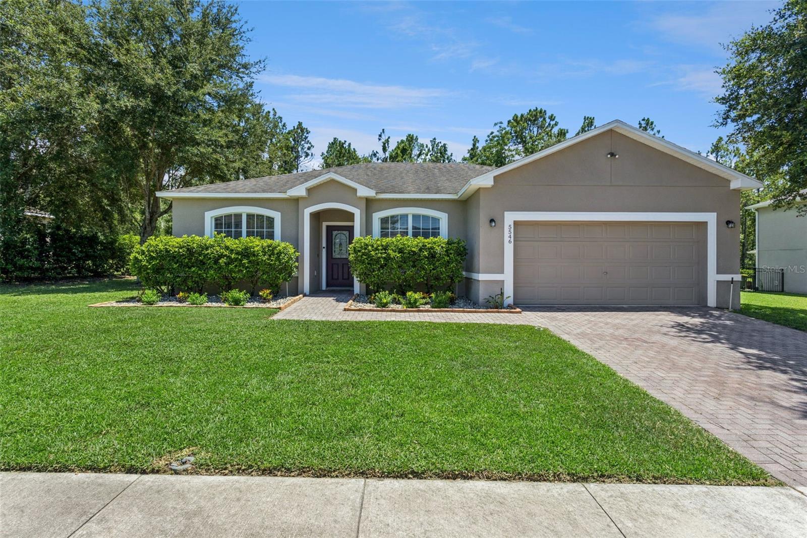 Move-in ready and priced to impress! This beautifully maintained 3-bedroom, 2-bath home with a 2-car garage offers 1,448 square feet of thoughtfully designed living space featuring a desirable split-bedroom floor plan and an open-concept layout perfect for both everyday living and entertaining. The spacious kitchen is the heart of the home, complete with Corian countertops, abundant cabinet and counter space, and a seamless flow into the living areas. Laminate flooring extends throughout the home with tile in the kitchen and bathrooms, creating a clean, modern look with easy maintenance. Fresh interior paint gives the home a bright, updated feel, and for added peace of mind, a brand-new roof will be installed prior to closing. The private primary suite is tucked away from the secondary bedrooms and features a large walk-in closet, dual vanities, and a spacious updated walk-in shower. Two additional bedrooms and a full bath provide plenty of flexibility for family, guests, or a home office. Step outside to enjoy the generously sized backyard with plenty of room for pets, play, gardening, or future outdoor living space with no rear neighbors. Located just minutes from Highway 27, you'll enjoy quick access to shopping, restaurants, grocery stores, schools, medical facilities, turnpike and major commuter routes. The community also features outstanding amenities including a community pool, tot lot, and dog park, making it easy to enjoy the Florida lifestyle. If you're searching for a move-in ready home with an open floor plan, fresh updates, a new roof, great community amenities, and an unbeatable location, this home checks all the boxes. Schedule your private showing today before this opportunity is gone! *Aerial photo property lines are an estimate and to be verified by buyer.