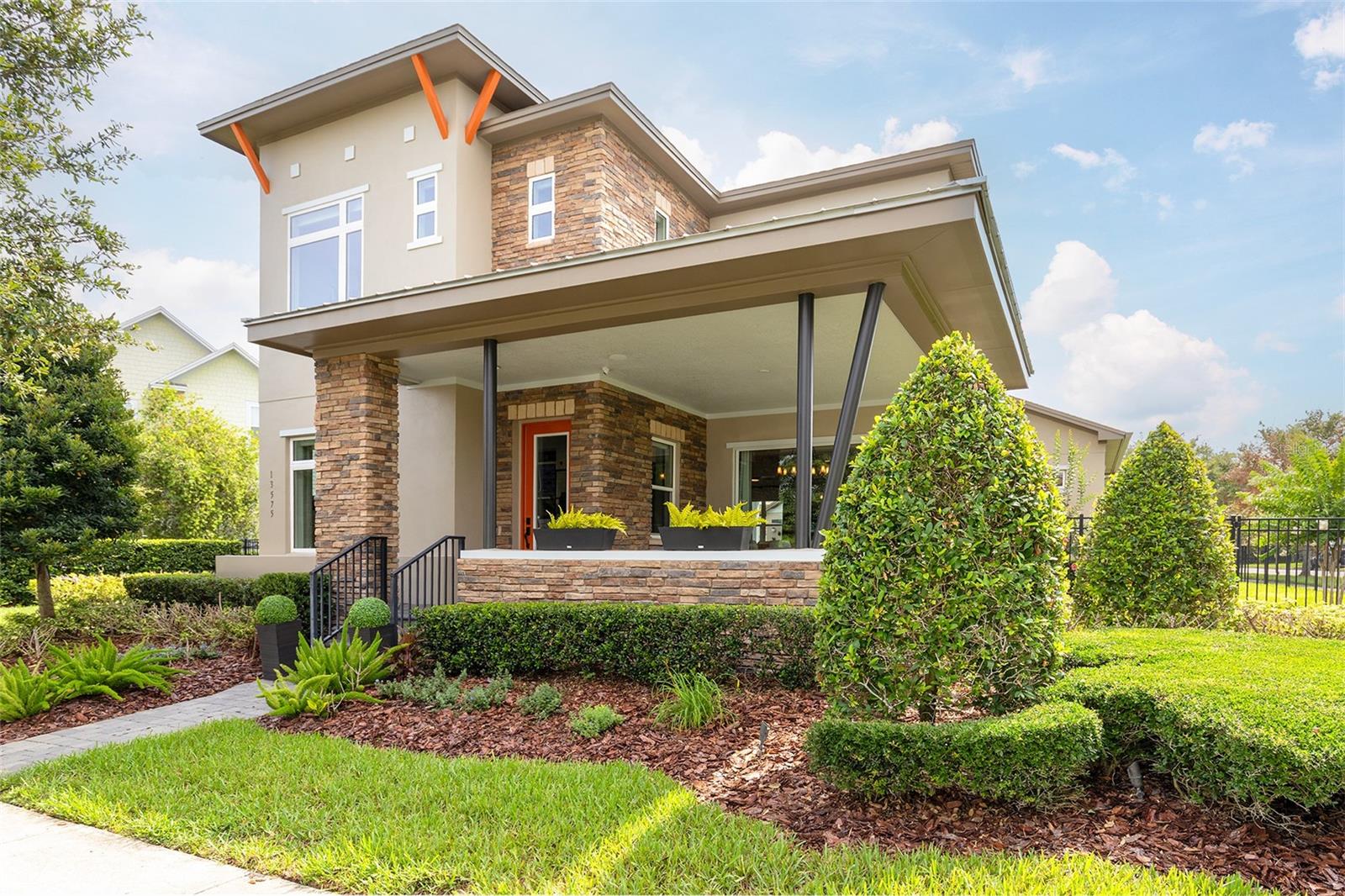 Welcome home! From the moment you arrive, the meticulous attention to detail is obvious. This stunning 5-bedroom, 4.5-bathroom residence boasts a model-like feel, complemented by delightful outdoor spaces and a first-floor, detached apartment with a private entrance, maximizing flexibility for daily living, entertaining guests, or multi-generational arrangements. Fresh exterior paint, tasteful brick accents, pristine landscaping, and fresh mulch provide impeccable curb appeal, while the covered front patio and sizable yard add to its charm. The main house is anchored by a gourmet kitchen overlooking the main living areas, showcasing Silestone countertops, a custom green tile backsplash, custom cabinetry with under-cabinet lighting, pendant and recessed lighting, a spacious island with bar seating, pantry closet, and GE appliances (refrigerator, wall oven, built-in microwave, dishwasher, and a vented cooktop with a pot filler). The custom touches extend throughout the home, with custom blinds framing the residence while recessed LED ceiling lights and designer pendant lighting illuminate each room with precision. Hardwood flooring flows from the entryway through the office, living room, dining room, kitchen, primary suite, and staircase, creating a sense of warmth and continuity. The spa-inspired bathrooms feature durable tile flooring, while plush neutral carpet softens the guest bedrooms and upstairs loft. Outside, the private covered patio extends entertaining space outdoors, complemented by a paver patio, private courtyard, covered front porch, and fenced backyard. These outdoor areas flow naturally from the main interior spaces, offering multiple zones for relaxation and gatherings. Since purchased in 2023, the sellers have lovingly upgraded this home, which was a model for the community when it was originally built. These upgrades include the perimeter fence, detached apartment and two-car garage, custom blinds, upgraded office glass door, exterior paint, enhanced landscaping, and Wi-Fi-enabled, Smart NEST thermostats for optimal climate control whether you are home or away. Tech features include whole-home surround sound wired for audio/visual, CAT 5 wiring, and a Gigabit network switch. Laureate Park delivers exceptional convenience and lifestyle amenities right in the heart of Lake Nona. Within the community, residents enjoy access to Canvas Restaurant & Market, LP Fit (residents-only fitness center), resort-style community pools and dedicated lap pools, multiple community parks, dog parks, tennis/pickleball courts, recreation activities, endless event programming, miles of trails, and Nona Adventure and Cable Park. Nearby, multiple Publix-anchored shopping centers, Sprouts, Sam’s Club, Walmart, and various plazas ensure that daily essentials are never far away. Proximity to Healthcare facilities is significant as well, with Nemours Children’s Hospital, VA Medical Center, HCA Oncology Specialists, The Cardiovascular Center of Florida, and UCF College of Medicine all nearby. Well-rated grade schools sit at the edge of the community, allowing for easy pickup/drop-off. At the same time, convenient highway access provides ideal connectivity for daily commuting or weekend adventures across Central Florida. Schedule your private showing today to experience this versatile property and prime location within this thriving community.