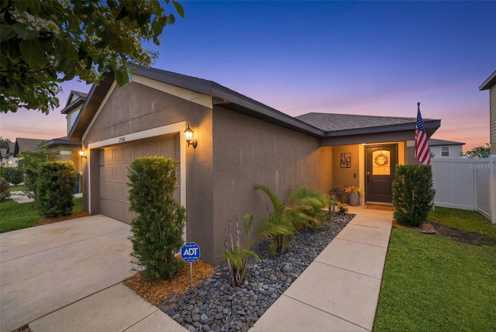 Welcome to Trilby Crossing, where builder-grade is left behind, and thoughtful upgrades take center stage. This beautifully maintained 3-bedroom, 2-bathroom home blends modern comfort with custom touches that elevate everyday living. Step inside to discover an open-concept floor plan featuring vinyl flooring, a spacious kitchen with granite countertops, stainless steel appliances, a large center island with seating, and seamless flow into the dining and living areas—perfect for entertaining or relaxing at home.

The private primary suite is a true retreat, showcasing a stunning custom accent wall, an oversized walk-in closet with built-in organization, and a beautifully updated en-suite bathroom with quartz countertops and a spacious walk-in shower. Two additional bedrooms and a secondary bath provide flexibility for guests, family, or a home office.

If you've been searching for new construction without the standard builder-grade finishes, you'll appreciate the meticulous upgrades throughout. Outside, enjoy your own backyard oasis featuring a shaded pergola dining area, raised sunbathing deck, covered lanai, custom paver walkways, and space for your very own vegetable garden. The fully fenced yard provides privacy while creating the perfect setting for outdoor gatherings and peaceful evenings.

Additional upgrades include a soft-start system on the HVAC, allowing the home to be powered by a properly sized generator through the installed generator inlet box—providing added convenience and peace of mind during storm season.

Even the garage has been transformed into a functional flex space with upgraded lighting, fitness area potential, and organized storage solutions. Conveniently located near shopping, dining, and everyday amenities, this move-in-ready home combines style, function, and thoughtful design.

Why wait for new construction when this one already has the upgrades completed for you?