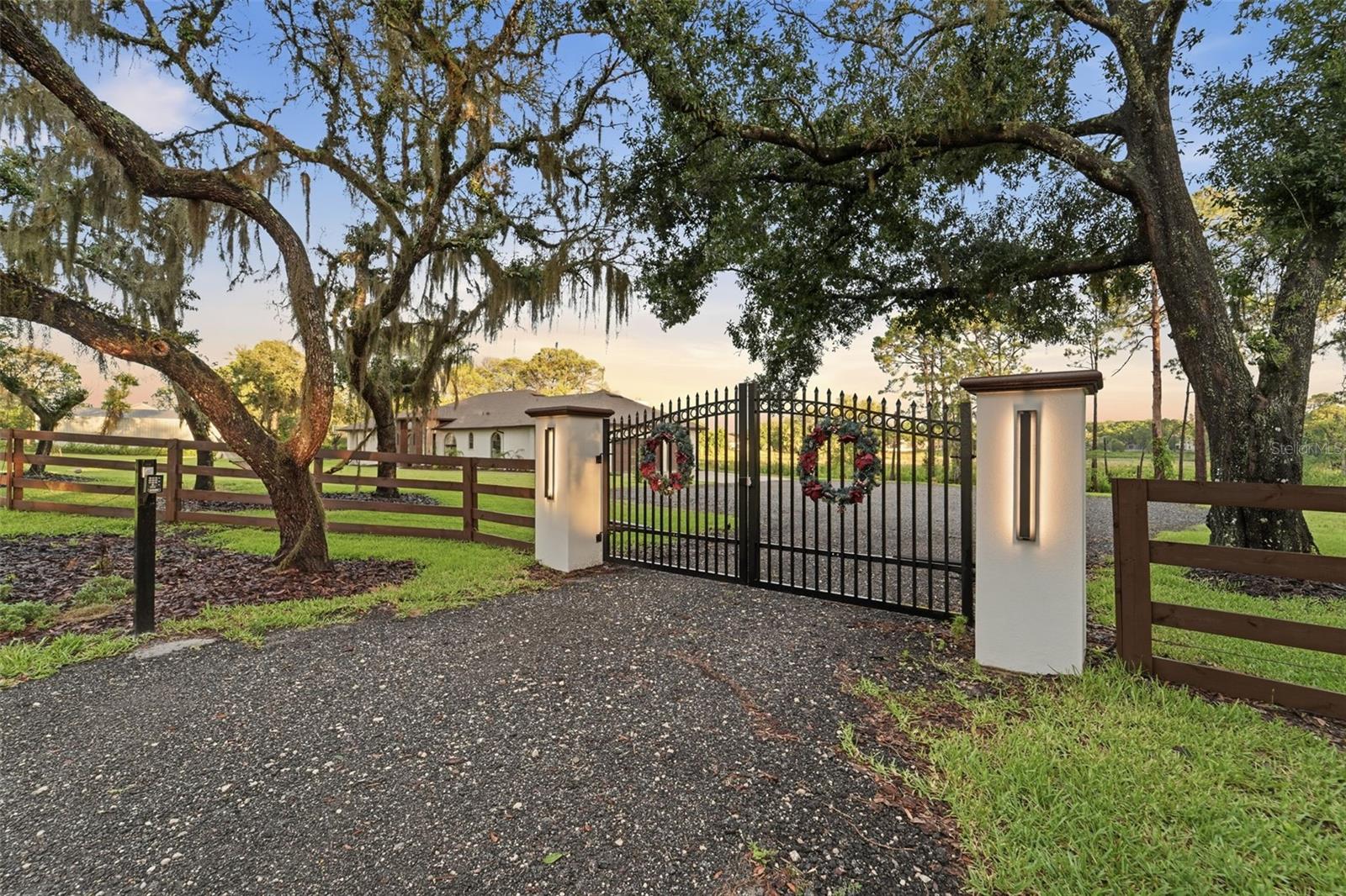 Rare opportunity to own a completely transformed, turnkey 5.2-acre agricultural lakefront estate on Lake Middlemass. Located in the heart of Seminole County with NO HOA, this highly desirable property sits directly across from Lake Sylvan and is zoned for the A-rated Wilson Elementary school (just a 2-minute drive away). Walking distance from Sylvan Lake Park, home to the Orlando Pride NWSL training grounds.Behind the secure, automated double-gate entry, the home offers a spacious 2,711 SQFT layout. No detail was spared in this top-to-bottom luxury renovation, offering absolute peace of mind with a whole-house plumbing re-pipe, seamless gutters, new interior/exterior paint, and energy-efficient LED lighting. Bring your largest toys. The oversized garage boasts ultra-high ceilings perfectly designed for boat parking.Roughly one acre of the main property is fully fenced, featuring a convenient gate that leads directly to your second vacant parcel. Because of the agricultural zoning, you have the rare freedom to build a massive workshop, a barn, a detached next-gen guest house, or an ultimate detached garage. Elite mechanical upgrades include newly installed FPUC natural gas lines, a gas tankless water heater, a premium water softener, and an Iron Boss water treatment system.Inside, brand-new luxury vinyl plank (LVP) flooring flows into a show-stopping chef's kitchen. This culinary masterpiece features luxury cabinets reaching the 10ft ceilings, premium waterfall-edge countertops, a massive island, and an elite appliance package with a gas cooktop, double oven, and drawer microwave. The open living space centers around a beautifully remodeled fireplace with a custom mantel. All three bathrooms have been completely reimagined, highlighted by a master retreat featuring a luxury standalone soaking tub, a custom rain-head shower, and a private 2–3 person sauna. The fully remodeled laundry room adds ultimate convenience with extra storage and versatile gas or electric dryer hookups.Step outside into your private backyard paradise. Extensive excavation has cleared over an acre of pristine lawn space, completed with fresh St. Augustine sod, professional landscaping, and a brand-new 10-zone irrigation system. Enjoy year-round outdoor living with a gas hot tub heater and a stunning outdoor gazebo set on a massive 25’x16’ concrete patio. Sports and entertainment enthusiasts will love the professional 30’x50’ concrete basketball half-court equipped with a MegaSlam XL Hoop. Storage is a breeze with an additional 10’x12’ concrete pad featuring a new Lifetime shed.This one-of-a-kind agricultural paradise perfectly blends high-end modern design, elite infrastructure, and endless possibilities. Schedule your private tour today!