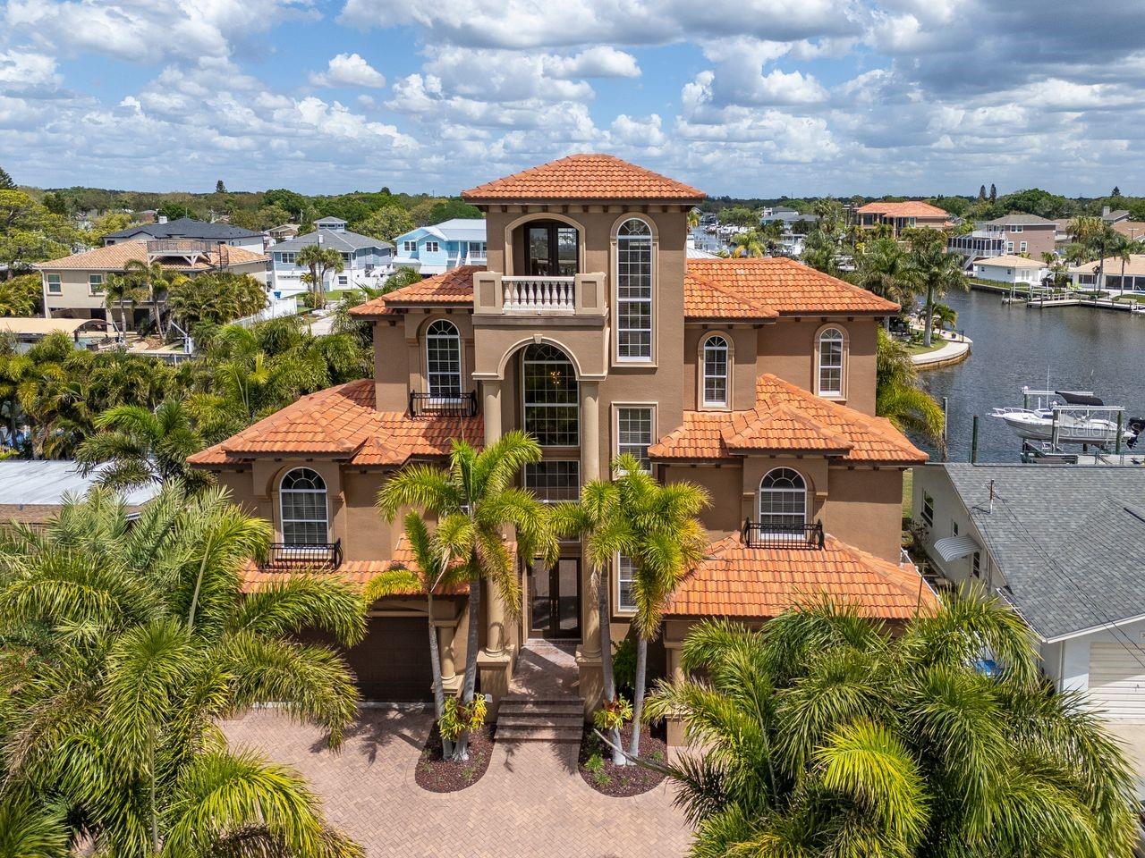 Welcome to your ultimate waterfront lifestyle in Baywood Village—where luxury, boating, and unforgettable sunsets come together in one exceptional property. This home was extremely well thought out and built upon 30 pilings, creating an extremely strong foundation for peace of mind.

Built in 2005, this custom home offers 2,720 square feet of well-designed living space with 660 square feet of bonus living space in the first level. This home features 3 bedrooms and 2 bathrooms, plus the huge bonus area downstairs with bonus bedroom and full bath—perfect for guests, a private suite, or flex space. The spacious split 4-car garage provides incredible storage for vehicles, toys, and gear.

Step outside and it gets even better. This property sits on a deep-water saltwater canal just minutes to open water, giving you true Gulf access with ease. Whether you're running offshore or cruising at sunset, this location delivers. The property is equipped with a 30,000 lb boat lift capable of handling up to a 42’ vessel with quad engines, and new lift bunks will convey. (Floating dock does not convey.)

The backyard is a private resort. Enjoy a stunning custom PebbleTec pool and spa, fully heated and surrounded by lush, mature landscaping with native palms that create a tropical, private setting. With new pool equipment, everything is turnkey and ready to enjoy from day one.

Inside, you’ll find thoughtful upgrades throughout, including a gas range, tankless gas water heater, and a new dishwasher. Two of the AC units were replaced in 2024, giving you added efficiency and peace of mind.

Take it all the way to the top—literally. The 4th-floor tower loft offers breathtaking panoramic views and unforgettable sunsets, making it the perfect place to unwind or entertain.

The paver driveway, mature palms, and overall curb appeal set the tone from the moment you arrive—this is a home that stands out.

Important note: Cameras are in use inside and outside the property.

This is more than a home—it’s a boater’s dream, a private retreat, and a rare opportunity in one of the area’s most desirable waterfront communities.

Don’t miss your chance to own this piece of paradise.