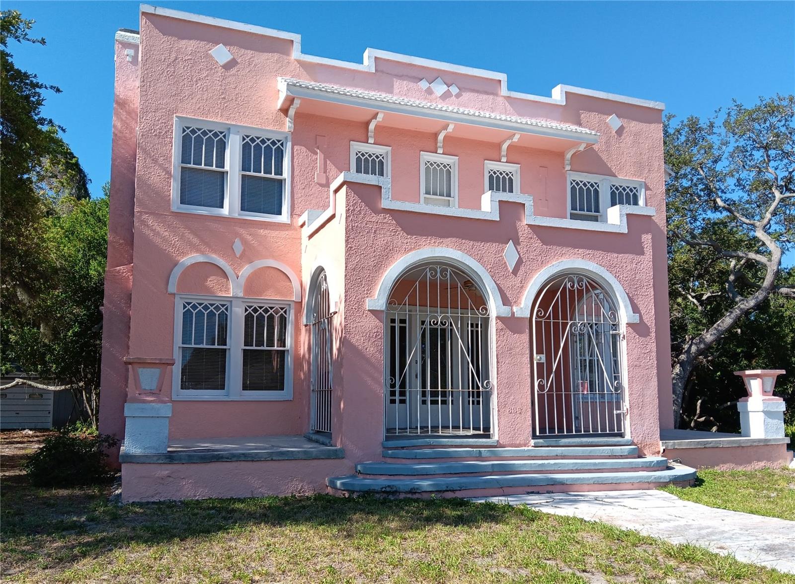 Charming Old Florida traditional home near Lake Maggiore is a mini-Don Cesar! It's chock full of classic architectural details like front porch pillars, decorative fireplace in the living room, carved trim on the double-hung windows. Rooms are spacious and the retro eat-in kitchen is equipped with stainless steel appliances. Three generously sized bedrooms and full bath are upstairs. Office or additional entertainment space is adjacent to the living room. Freshly painted and carpeted. First floor bathroom has a shower. Washer-dryer available in garage is shared with back tenant. Off-street parking. Walk to Lake Maggiore Park for a picnic, for the playground or to enjoy the water birds.