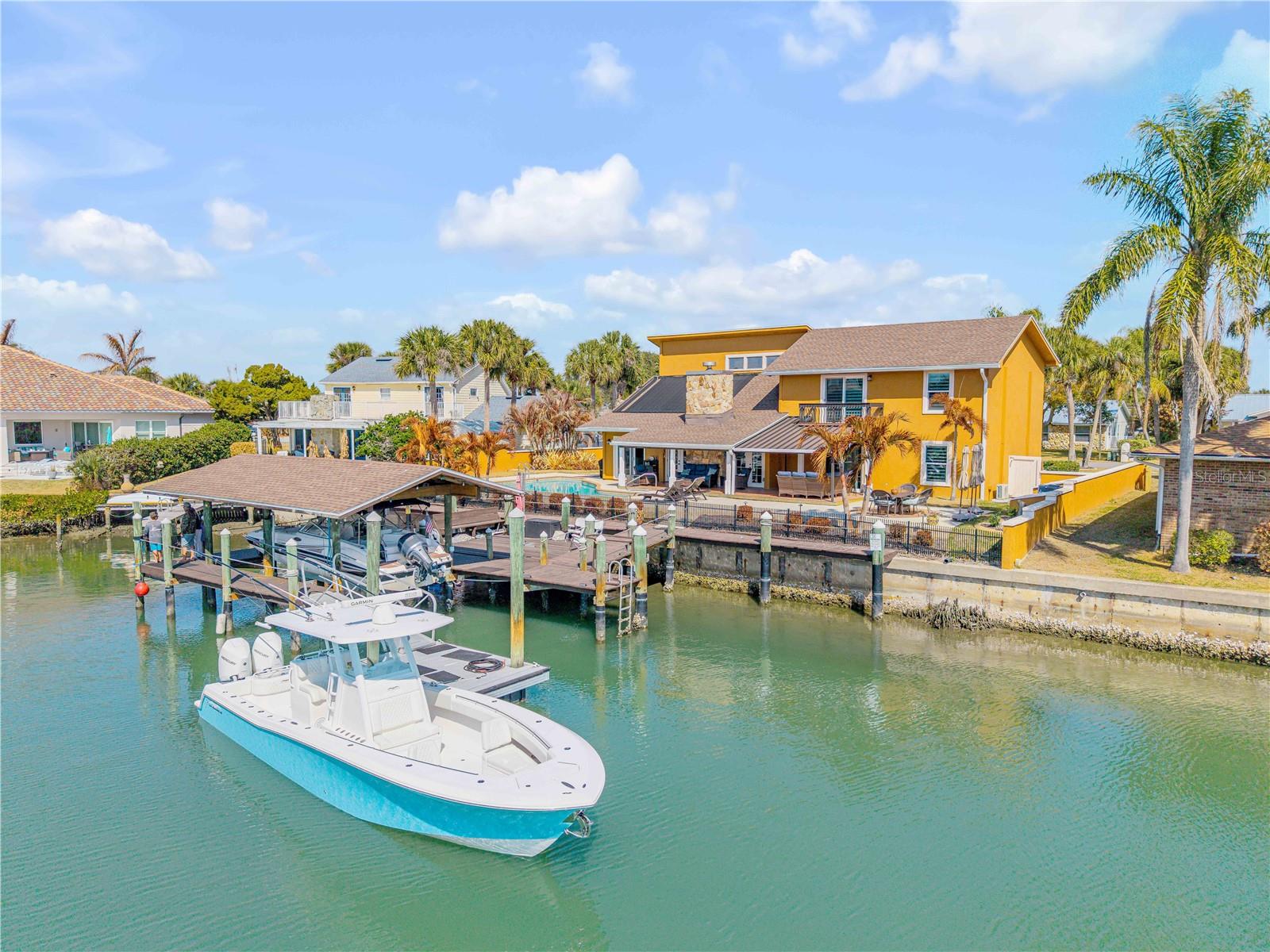 Back on the market! No fault of the seller.  Their loss is your opportunity! Now presenting 102 Via Duomo — a deep-water pool home in the heart of Venezia, one of New Smyrna Beach’s most sought-after waterfront communities. Venezia isn’t just a neighborhood — it’s a lifestyle. Central, deep-water access, friendly neighbors, quiet streets, and even community pickleball courts. It’s the kind of place where people move in and stay.
Perfectly positioned on a serene cul-de-sac, this 3-bedroom, 3-bath residence offers direct boating access from your backyard with plenty of room for multiple boats and water toys on your 100' wide riverfront backyard. Whether you’re cruising offshore or enjoying sunset river rides, this is true deep-water living. Seller will entertain owner financing. 
From the moment you arrive, the curb appeal sets the tone — mature palms, manicured landscaping, and a paver driveway welcome you home. Inside, soaring ceilings and abundant natural light create an airy, open feel. French doors frame peaceful water views, while a wood-burning fireplace adds warmth and character to the main living space.
The kitchen is designed for both everyday living and entertaining, featuring stainless steel appliances, granite countertops, custom cabinetry with molding detail, a decorative backsplash, and an island with breakfast bar seating beneath statement lighting. It flows seamlessly into the dining and living areas, making gatherings effortless.
The primary suite is generously sized with a sitting area, walk-in closet, and private bath — a true retreat at the end of the day. Upstairs, a spacious loft with built-in shelving and skylights offers flexibility for an office, media room, or additional lounge space, alongside two oversized additional bedrooms and a full bath.
Step outside and the lifestyle truly unfolds. A covered patio overlooks the sparkling pool, recently enhanced with a new Harvard pool pump and saltwater system in 2023. Beyond that, your covered boathouse includes a lift, water, electricity, and a dedicated fish-cleaning station — because in Venezia, boating isn’t occasional… it’s part of daily life.
Major updates provide peace of mind, including a new roof in 2022 and updated A/C systems in 2022 and 2023, with dual central HVAC units and mini-splits for individual bedroom comfort.
Located just minutes from Flagler Avenue, Canal street,  local dining, shopping, and New Smyrna’s beaches, this home combines convenience with the privacy as you are a quick golf cart ride or boat ride from everything NSB has to offer.
Deep-water. Central location. A community people genuinely love.
This is the Venezia lifestyle.