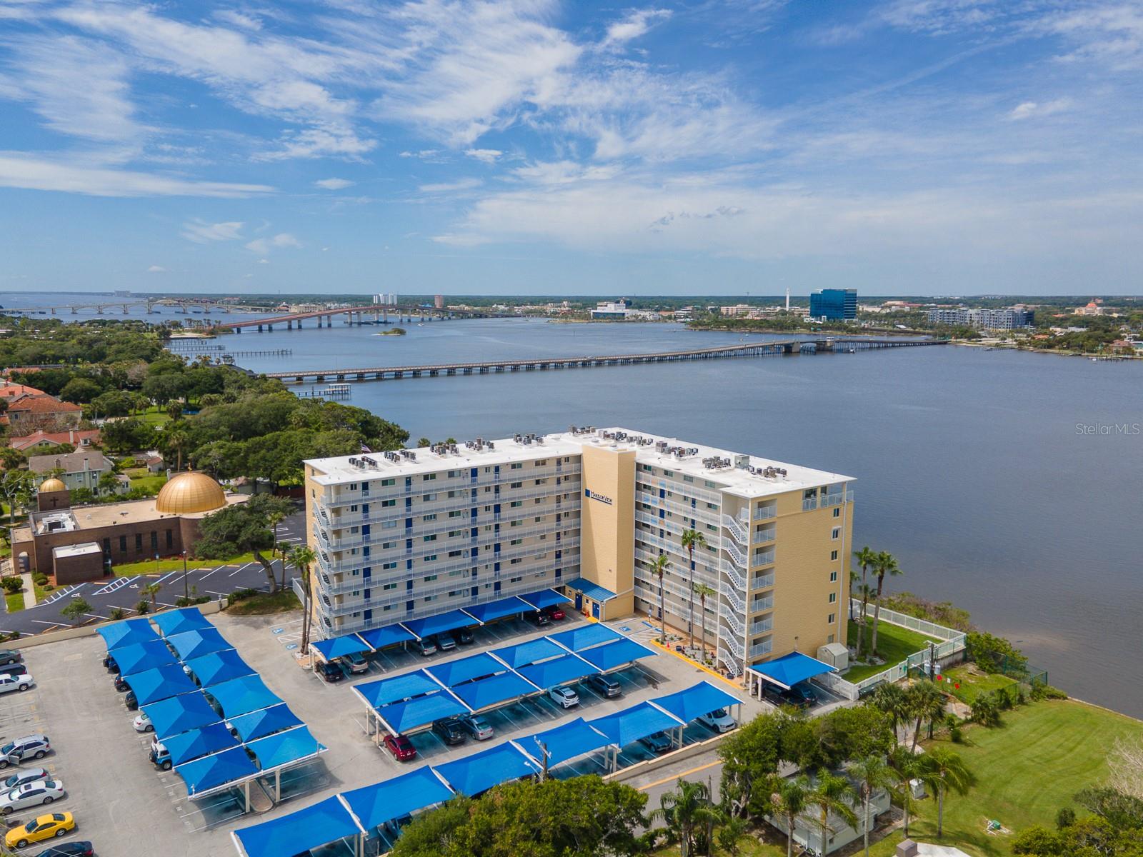 Wake up to breathtaking panoramic views of the Halifax River from this sought-after 7th-floor end unit in Harbor View Condo. Perfectly positioned to capture some of the building’s most impressive waterfront vistas, this tastefully furnished condominium offers a light-filled interior, added privacy, and spectacular views of the Intracoastal Waterway, Caribbean Jack’s Marina, colorful sunsets, boat traffic, and the vibrant Daytona Beach skyline.
Designed for easy coastal living, this condo features a beautifully maintained interior with tile flooring in the entry, kitchen, and baths, paired with luxury vinyl plank throughout the main living areas and bedrooms for a clean, cohesive, and low-maintenance finish. The kitchen is equipped with new stainless steel appliances, adding modern convenience and a polished touch to this inviting waterfront residence.
Whether you’re searching for a full-time residence, seasonal retreat, or investment opportunity, this move-in-ready condo delivers comfort, convenience, and an unbeatable waterfront lifestyle. For added peace of mind, major building improvements have already been completed, including a new roof and significant community updates. Residents enjoy resort-style amenities, including a waterfront pool and spa, while being just minutes from the beach, boardwalk, dining, shopping, entertainment, and all that Daytona Beach has to offer.