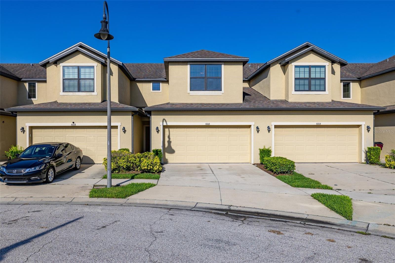 Welcome to this well maintained townhome with NO REAR NEIGHBOURS in the desirable GATED COMMUNITY of Oak Ridge Place in St. Cloud! Offering the perfect combination of comfort, style, and convenience, this MOVE-IN READY HOME features a spacious OPEN-CONCEPT LAYOUT with TILED FLOORING throughout the entire first floor. The well-appointed KITCHEN showcases GRANITE COUNTERTOPS, kitchen bar with seating, STAINLESS STEEL APPLIANCES, roomy 42” CABINETS, recessed lighting. The kitchen overlooks the main living and dining areas - perfect for entertaining. A custom-built bar is negotiable and may convey with an acceptable offer, creating the ideal space for hosting family and friends. The first floor also includes a convenient half bath and multiple storage spaces for added functionality. UPDATED LIGHT FIXTURES throughout the home add a stylish finish. Step outside to enjoy the EXTENDED SCREENED LANAI, providing the perfect place to relax year-round with added privacy and outdoor living space. UPSTAIRS, you’ll find all bedrooms featuring DURABLE LAMINATE FLOORING. The spacious PRIMARY SUITE offers a large WALK-IN CLOSET, DOUBLE SINKS with solid surface countertops, TILED WALK-IN SHOWER, UPGRADED LIGHT FIXTURE and HARDWARE for a modern touch. Additional bedrooms are generously sized and all have CEILING FANS. Upstairs LAUNDRY CLOSET with Samsung WASHER and DRYER included in the sale. ADDITIONAL UPGRADES include smart Echo thermostat and energy-efficient DOUBLE-PANE WINDOWS, helping enhance comfort while reducing energy costs. The ATTACHED TWO-CAR GARAGE and private driveway provide ample parking and storage. Residents of Oak Ridge Place enjoy a gated entrance, COMMUNITY POOL and CABANA, PLAYGROUND; LAWN CARE is included through the HOA. ***NO CDD fees***, and a very reasonable HOA, making homeownership both convenient and affordable. Well-located just minutes from Florida’s Turnpike, this home offers quick access to Lake Nona, Medical City, Downtown Orlando, Orlando International Airport, shopping, dining, entertainment, and Florida’s beautiful east coast beaches. Whether you’re looking for a primary residence or a low-maintenance lifestyle in a growing area, this home checks all the boxes. Don’t miss the opportunity to make this exceptional home your own - schedule a private showing today!